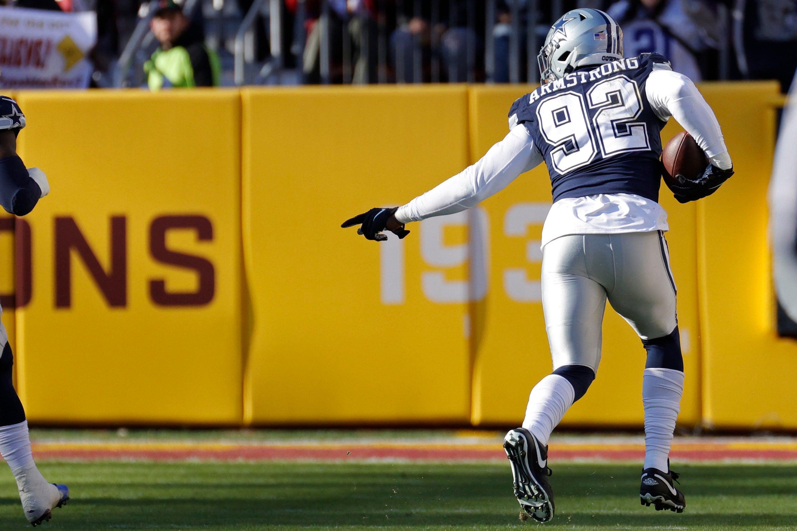 Dec 12, 2021; Landover, Maryland, USA; Dallas Cowboys defensive end Dorance Armstrong (92) returns a fumble for a touchdown against the Washington Football Team during the second quarter at FedExField. Mandatory Credit: Geoff Burke-USA TODAY Sports