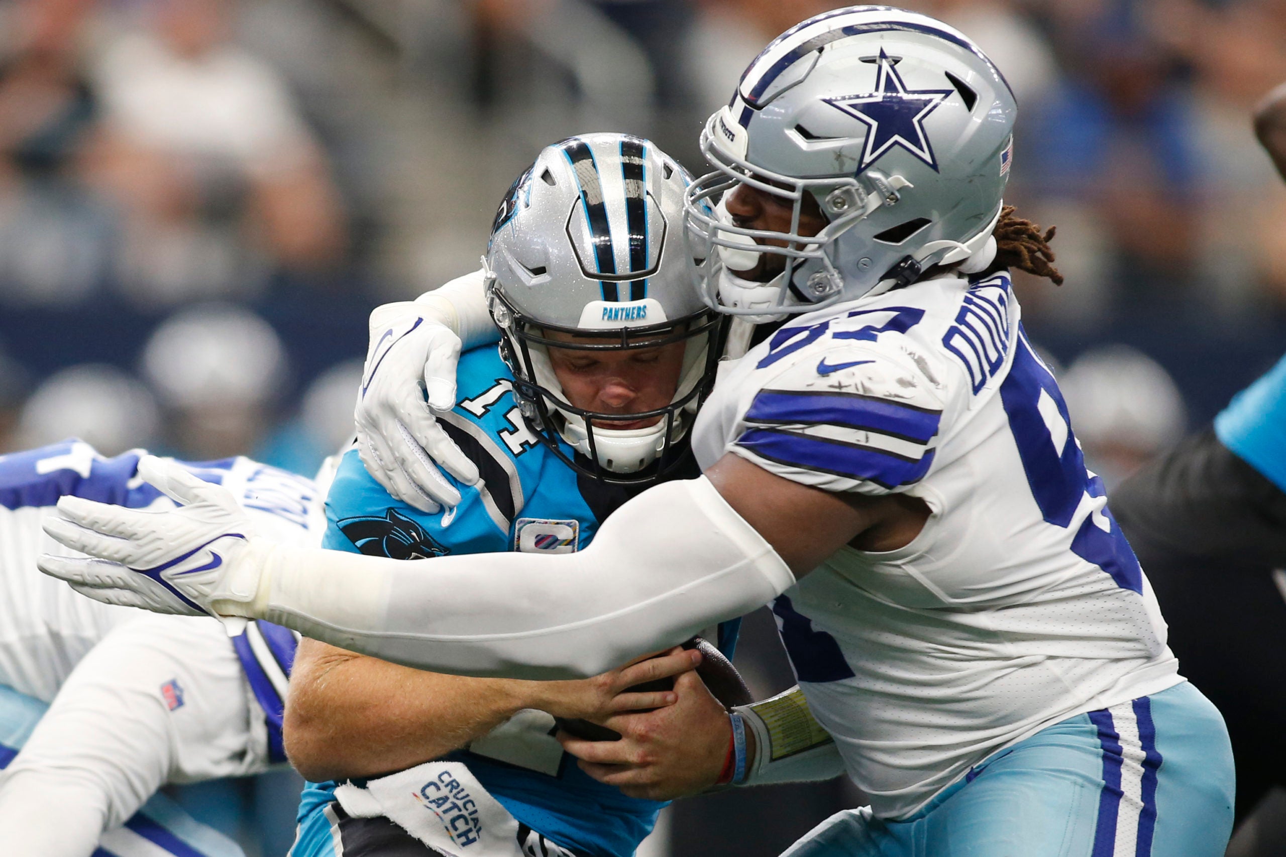 Oct 3, 2021; Arlington, Texas, USA; Carolina Panthers quarterback Sam Darnold (14) is hit by Dallas Cowboys defensive tackle Osa Odighizuwa (97) in the third quarter at AT&T Stadium. Mandatory Credit: Tim Heitman-USA TODAY Sports