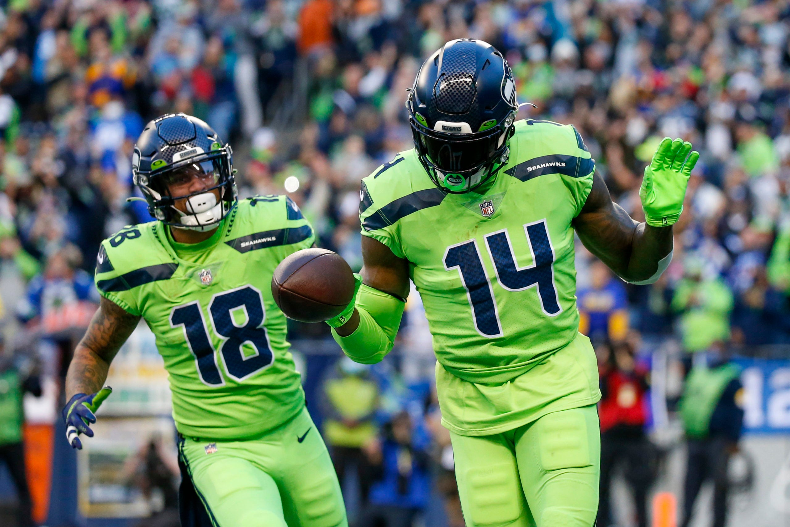 Oct 7, 2021; Seattle, Washington, USA; Seattle Seahawks wide receiver DK Metcalf (14) celebrates with wide receiver Freddie Swain (14) after catching a touchdown pass against the Los Angeles Rams during the second quarter at Lumen Field. Mandatory Credit: Joe Nicholson-USA TODAY Sports