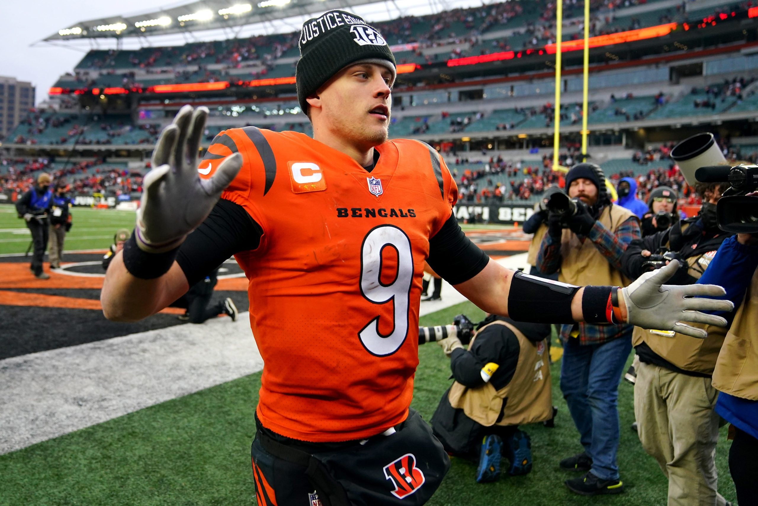 Cincinnati Bengals quarterback Joe Burrow (9) high fives fans at the conclusion of Week 17 NFL game against the Kansas City Chiefs, Sunday, Jan. 2, 2022, at Paul Brown Stadium in Cincinnati. The Cincinnati Bengals defeated the Kansas City Chiefs, 34-31. With the win the, the Cincinnati Bengals won the AFC North division and advance to the NFL playoffs. Kansas City Chiefs At Cincinnati Bengals Jan 2