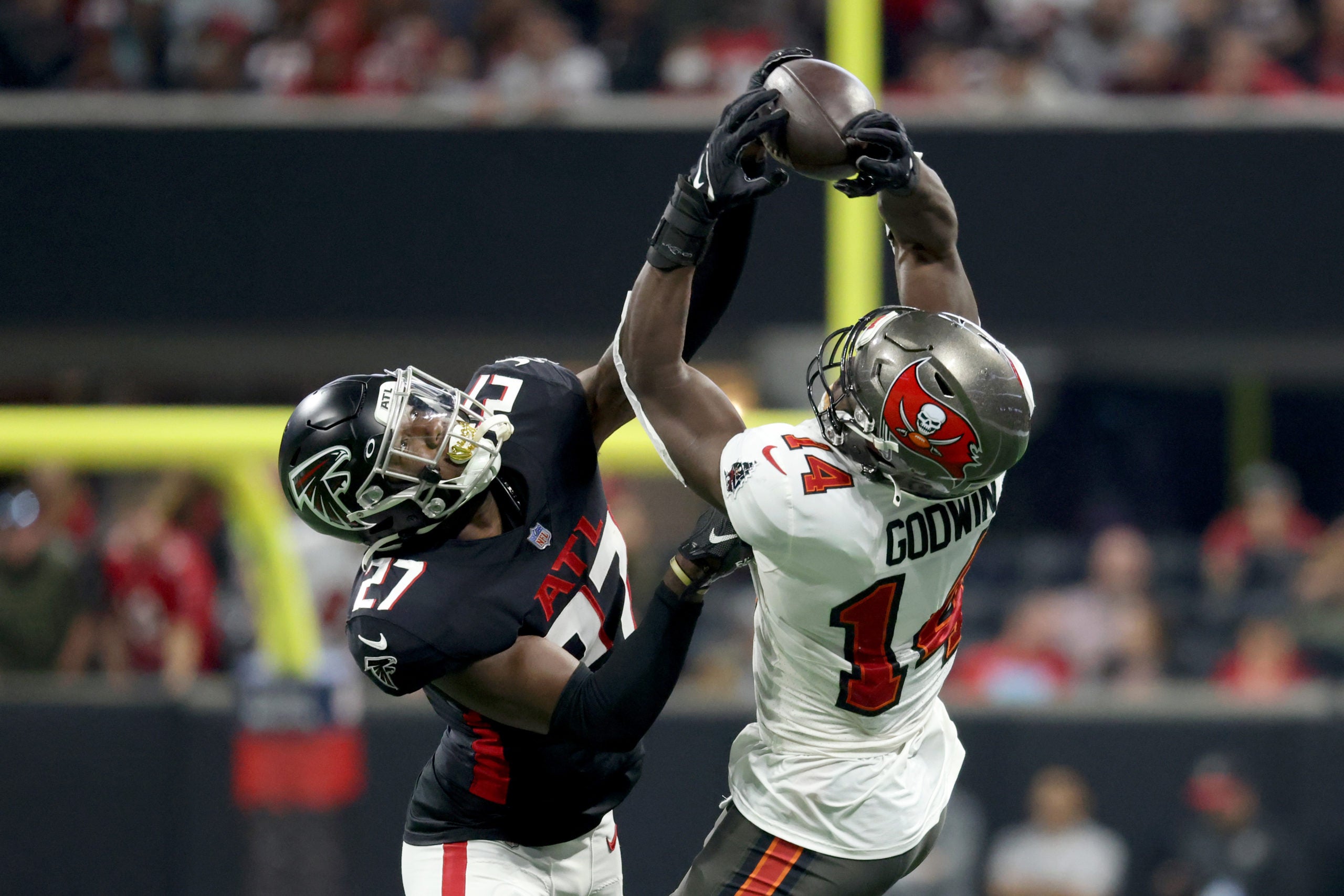 Dec 5, 2021; Atlanta, Georgia, USA; Tampa Bay Buccaneers wide receiver Chris Godwin (14) makes a catch against Atlanta Falcons safety Richie Grant (27) during the first quarter at Mercedes-Benz Stadium. Mandatory Credit: Jason Getz-USA TODAY Sports