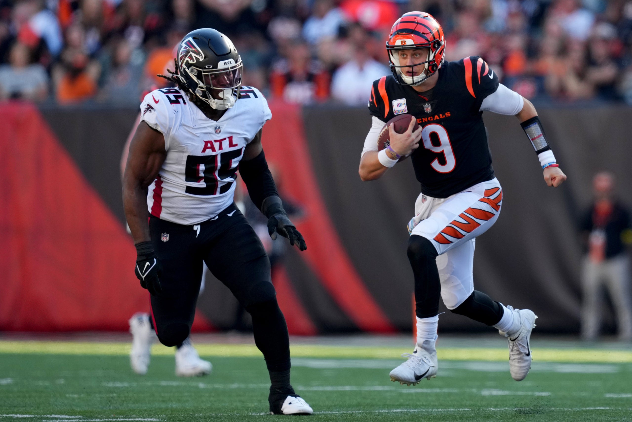 Oct 23, 2022; Cincinnati, Ohio, USA; Cincinnati Bengals quarterback Joe Burrow (9) carries the ball in the fourth quarter during a Week 7 NFL game against the Atlanta Falcons, Sunday, Oct. 23, 2022, at Paycor Stadium in Cincinnati. Mandatory Credit: Kareem Elgazzar-USA TODAY Sports