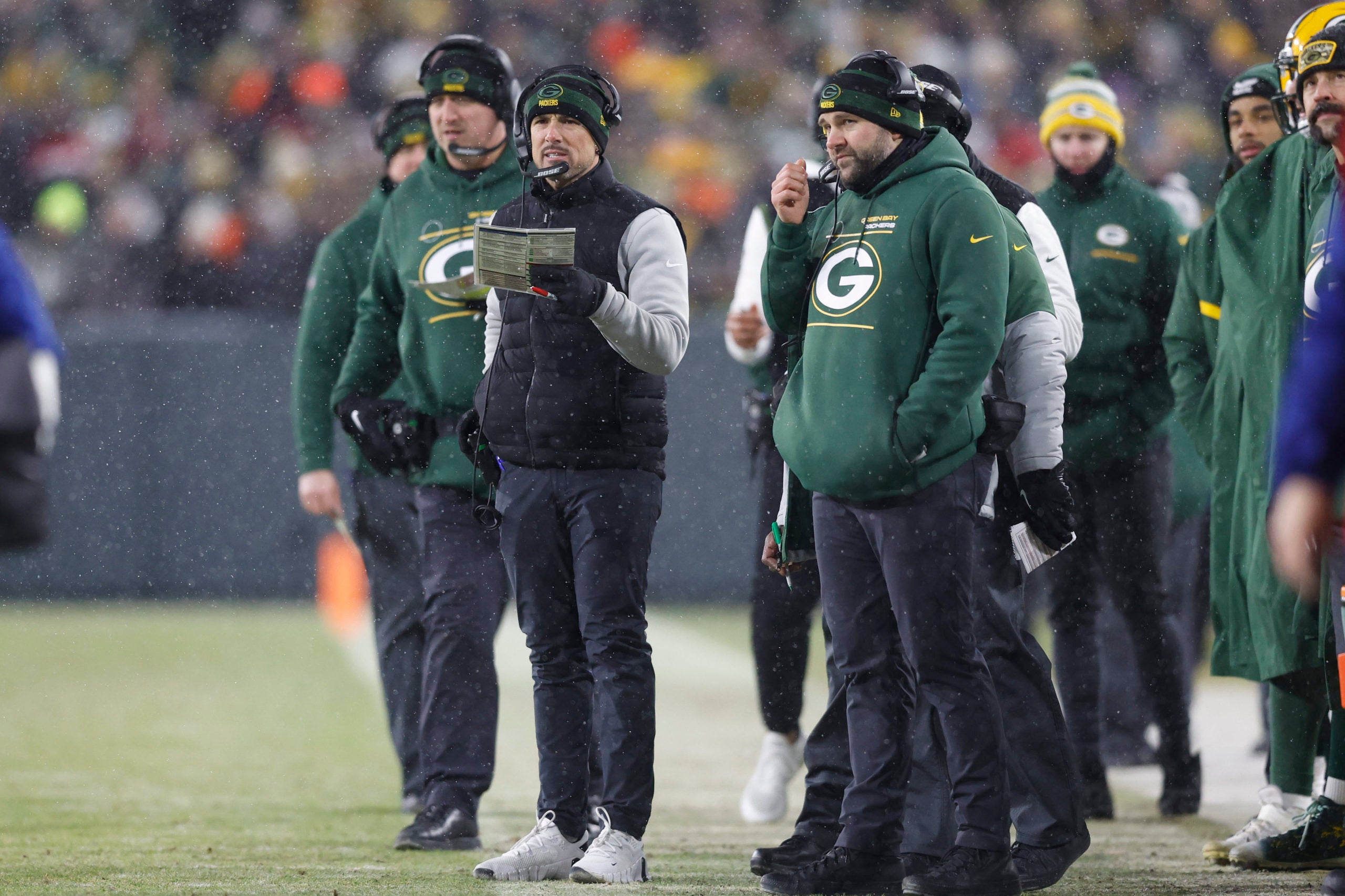Jan 22, 2022; Green Bay, Wisconsin, USA; Green Bay Packers head coach Matt LaFleur (center) looks on from the sidelines in the second half against the San Francisco 49ers during a NFC Divisional playoff football game at Lambeau Field. Mandatory Credit: Jeff Hanisch-USA TODAY Sports