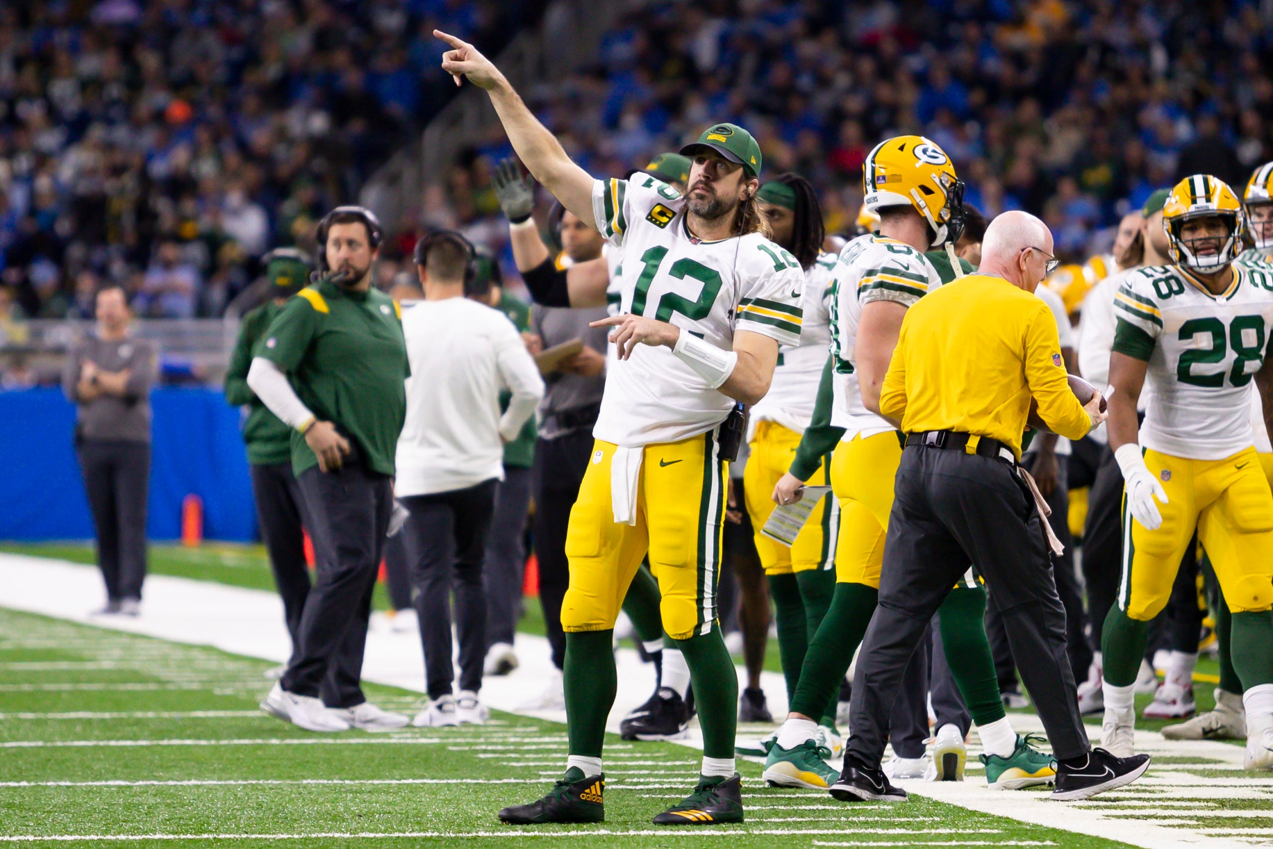 Jan 9, 2022; Detroit, Michigan, USA; Green Bay Packers quarterback Aaron Rodgers (12) points to the other side of the field during the fourth quarter against the Detroit Lions at Ford Field. Mandatory Credit: Raj Mehta-USA TODAY Sports
