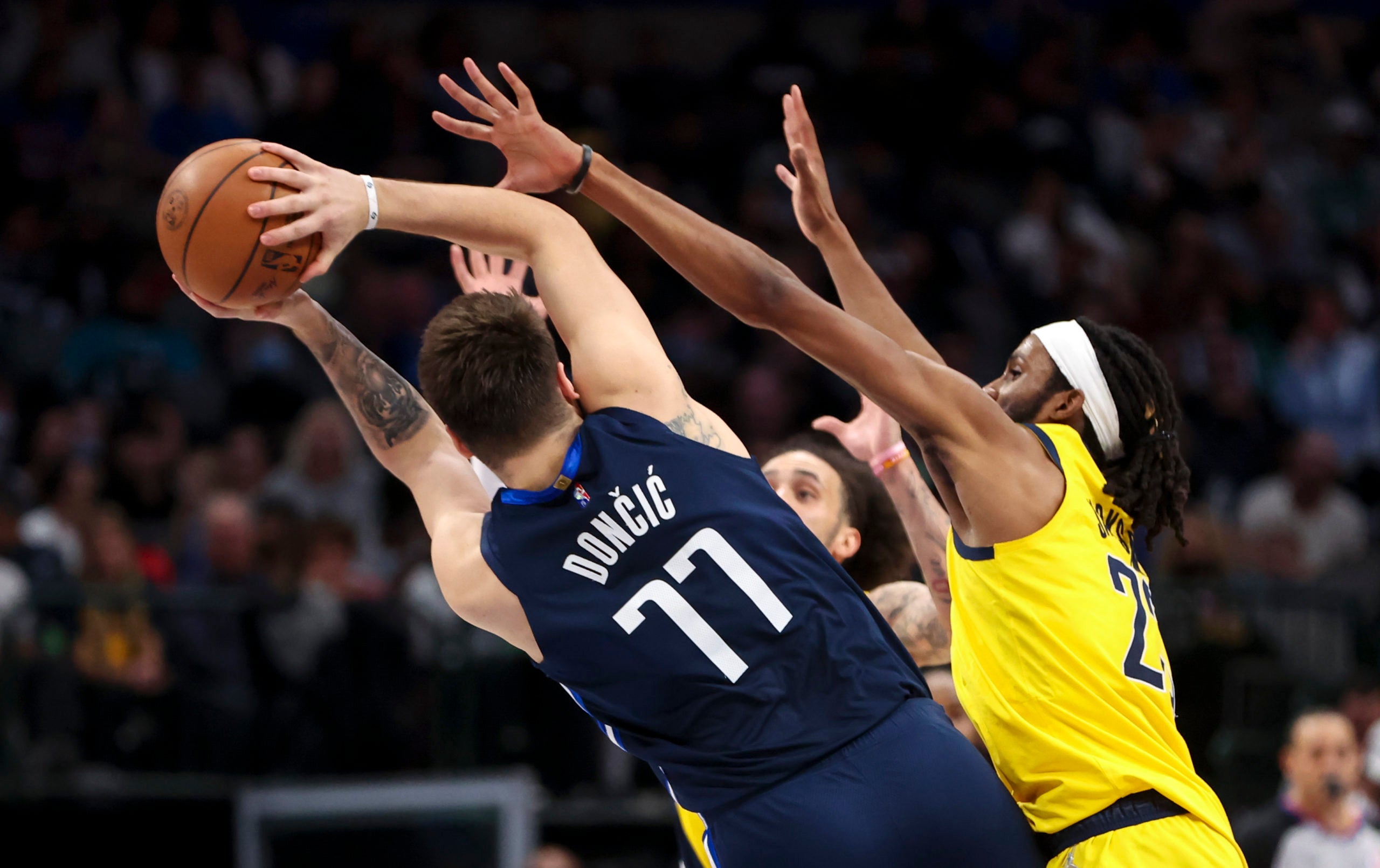 Jan 29, 2022; Dallas, Texas, USA;  Dallas Mavericks guard Luka Doncic (77) throws a pass as Indiana Pacers forward Isaiah Jackson (23) defends during the second half at American Airlines Center. Mandatory Credit: Kevin Jairaj-USA TODAY Sports