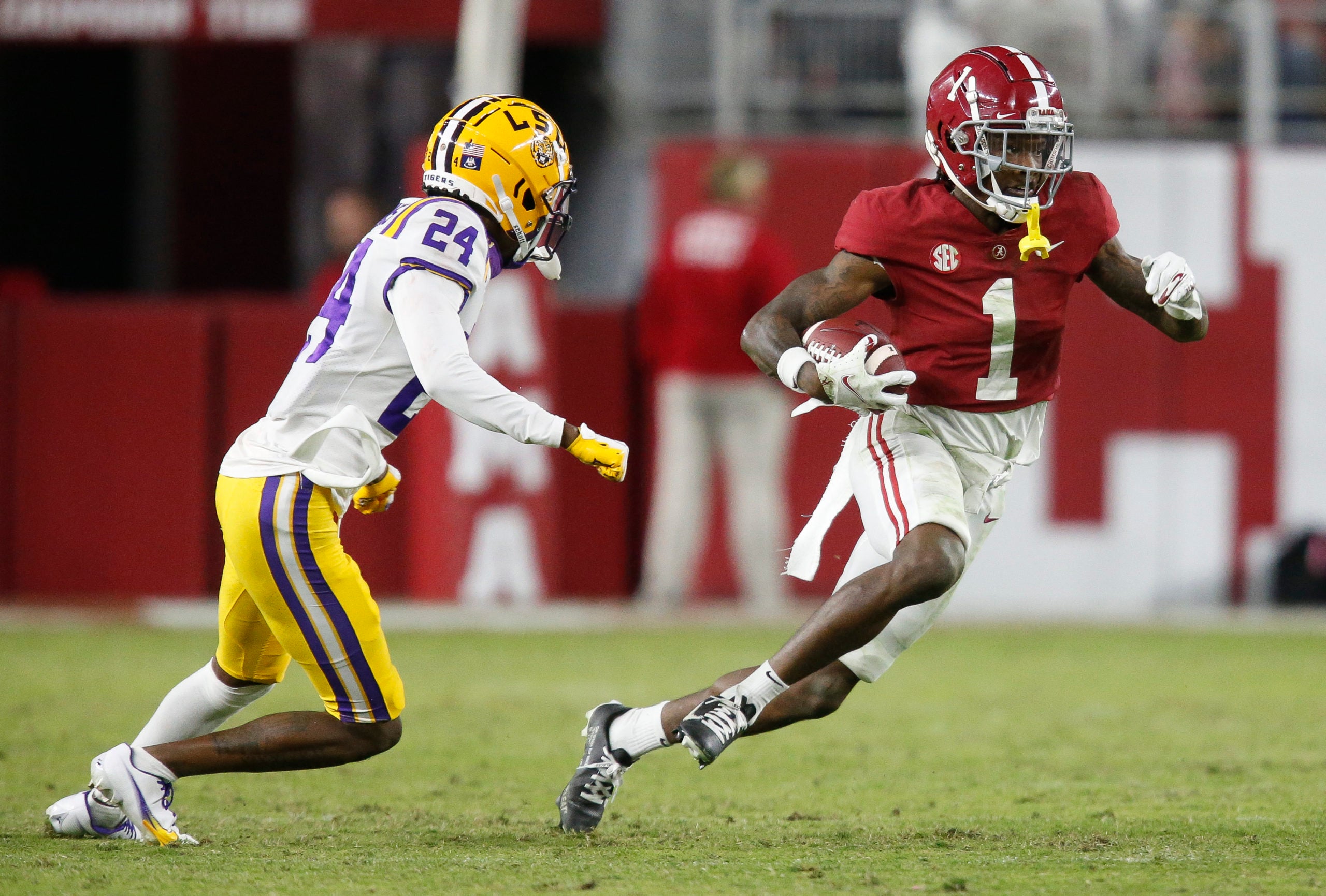 Nov 6, 2021; Tuscaloosa, Alabama, USA; Alabama Crimson Tide wide receiver Jameson Williams (1) runs the ball against LSU Tigers defensive back Darren Evans (24) at Bryant-Denny Stadium. Alabama won 20-14. Mandatory Credit: Gary Cosby Jr.-USA TODAY Sports