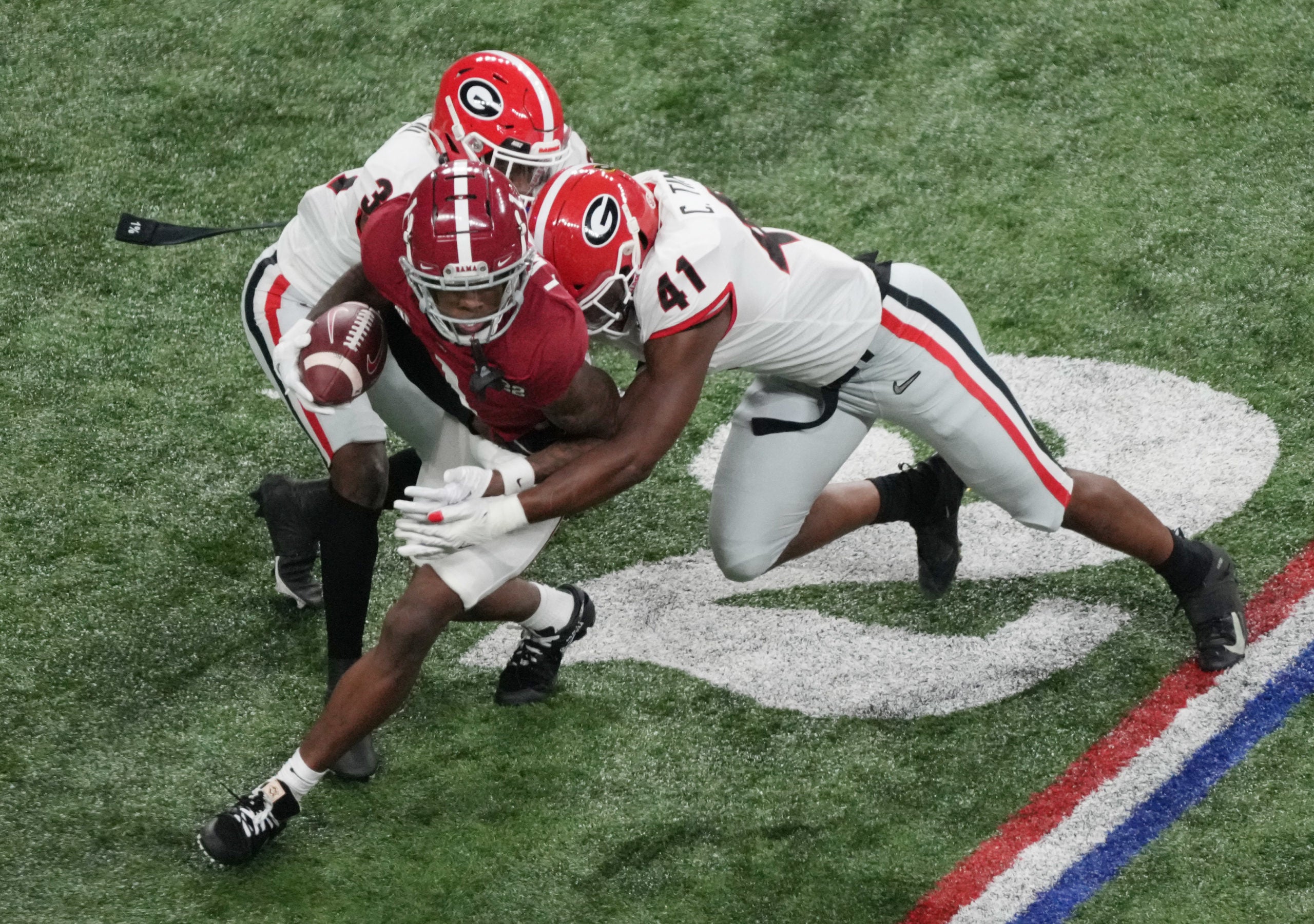 Jan 10, 2022; Indianapolis, IN, USA; Alabama Crimson Tide quarterback Bryce Young (9) is tackled by Georgia Bulldogs linebacker Channing Tindall (41) in the first quarter during the 2022 CFP college football national championship game at Lucas Oil Stadium. Mandatory Credit: Joshua Bickel-USA TODAY Sports