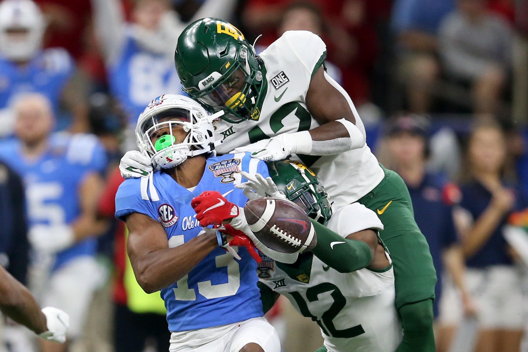 Jan 1, 2022; New Orleans, LA, USA; Mississippi Rebels wide receiver Braylon Sanders (13) cannot hold on to the football against Baylor Bears safety Jairon McVea (top) and cornerback Kalon Barnes (12) in the third quarter of the 2022 Sugar Bowl at the Caesars Superdome. Mandatory Credit: Chuck Cook-USA TODAY Sports