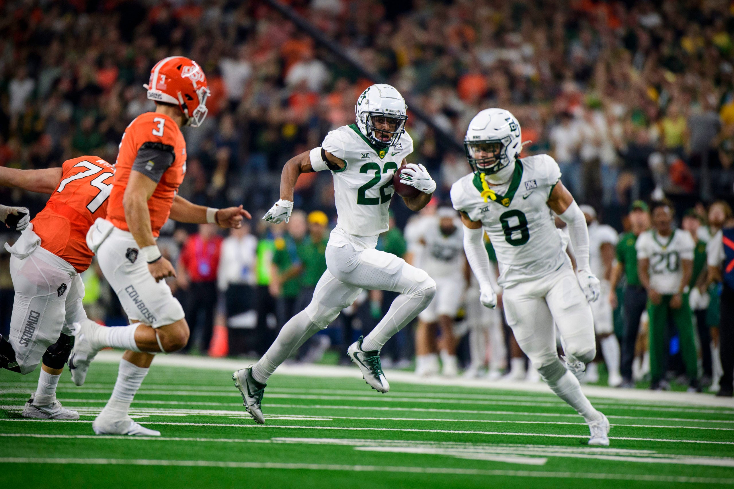Dec 4, 2021; Arlington, TX, USA; Baylor Bears safety JT Woods (22) returns an interception against the Oklahoma State Cowboys during the first quarter in the Big 12 Conference championship game at AT&T Stadium. Mandatory Credit: Jerome Miron-USA TODAY Sports