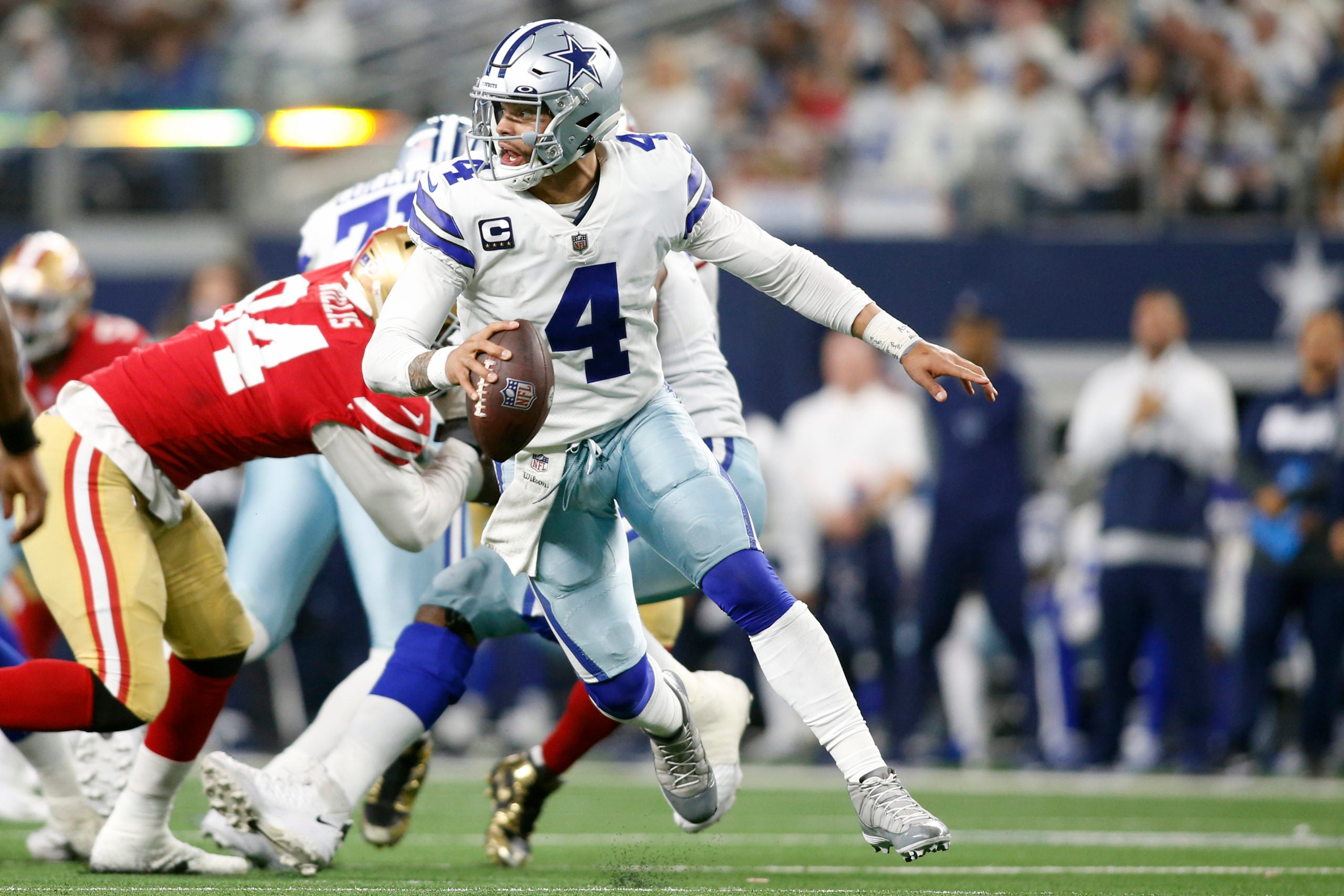 Jan 16, 2022; Arlington, Texas, USA; Dallas Cowboys quarterback Dak Prescott (4) scrambles in the third quarter against the San Francisco 49ers in a NFC Wild Card playoff football game at AT&T Stadium. Mandatory Credit: Tim Heitman-USA TODAY Sports