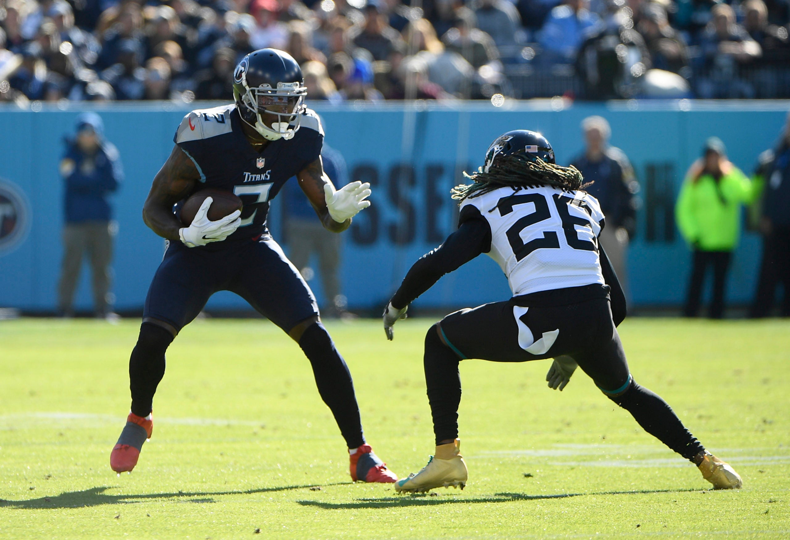 Dec 12, 2021; Nashville, Tennessee, USA; Tennessee Titans wide receiver Julio Jones (2) runs the ball as Jacksonville Jaguars cornerback Shaquill Griffin (26) defends during first half at Nissan Stadium. Mandatory Credit: Steve Roberts-USA TODAY Sports