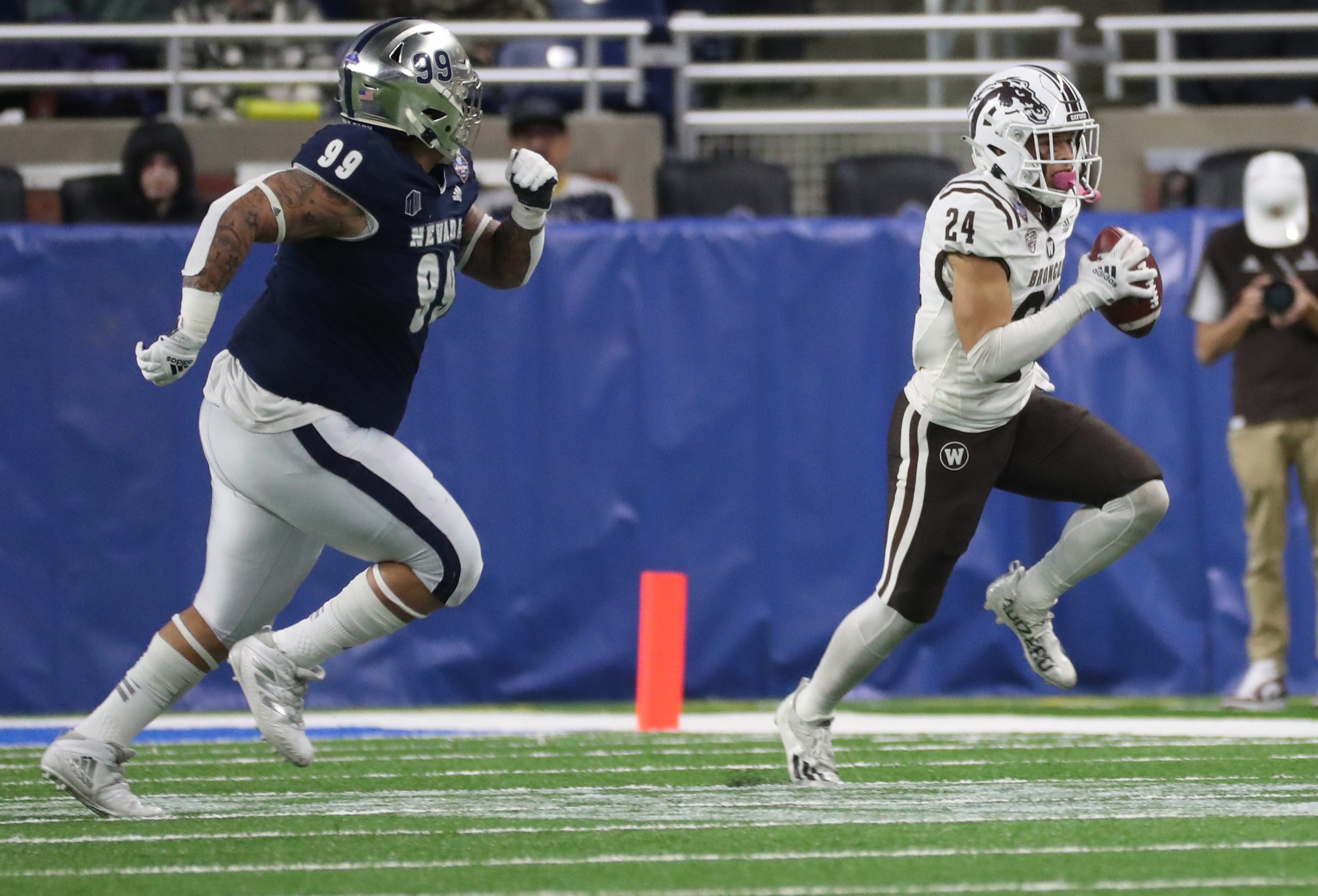 Western Michigan wide receiver Skyy Moore runs by Nevada defensive tackle Dom Peterson during the first half of the Quick Lane Bowl on Monday, Dec. 27, 2021, at Ford Field. Quick Lane