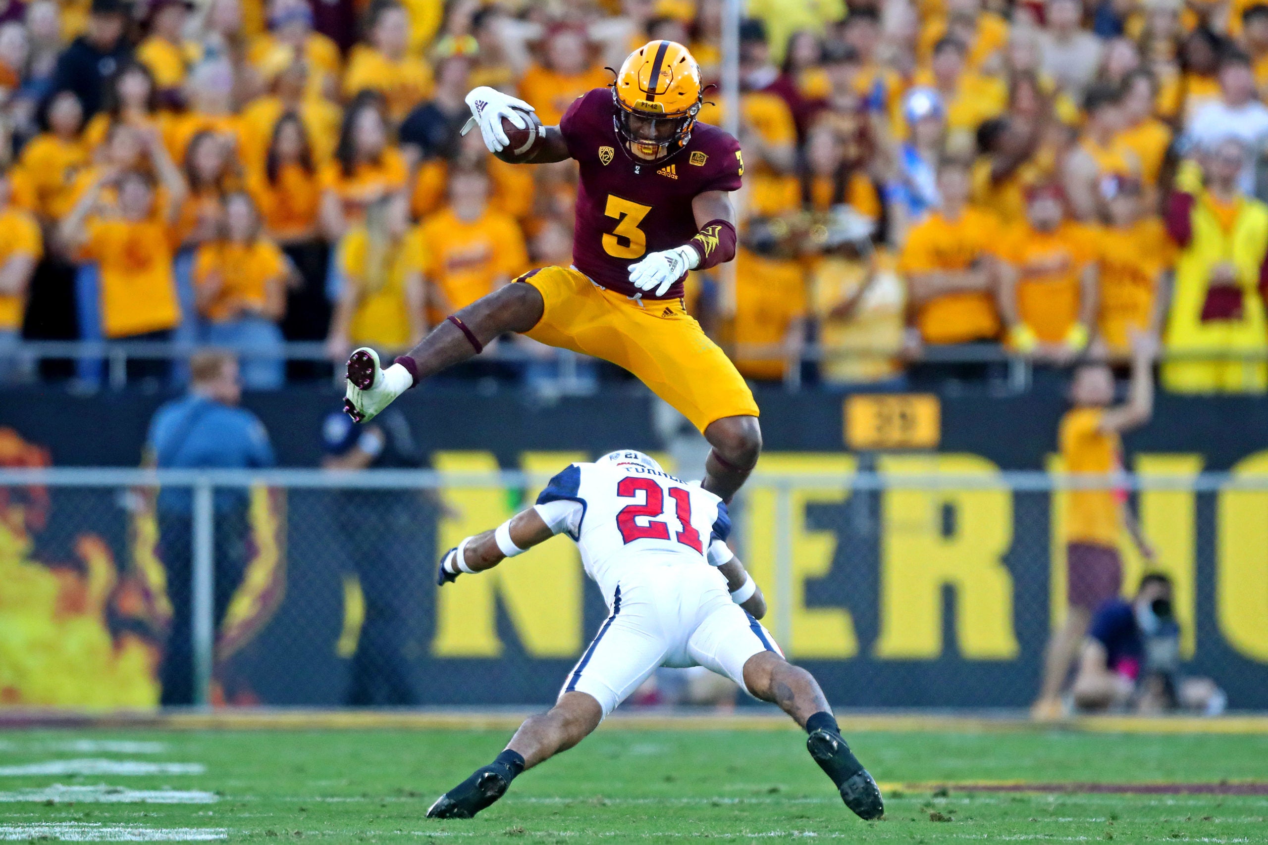 Nov 27, 2021; Tempe, Arizona, USA; Arizona State Sun Devils running back Rachaad White (3) jumps over Arizona Wildcats safety Jaxen Turner (21) during the second half at Sun Devil Stadium. Mandatory Credit: Mark J. Rebilas-USA TODAY Sports