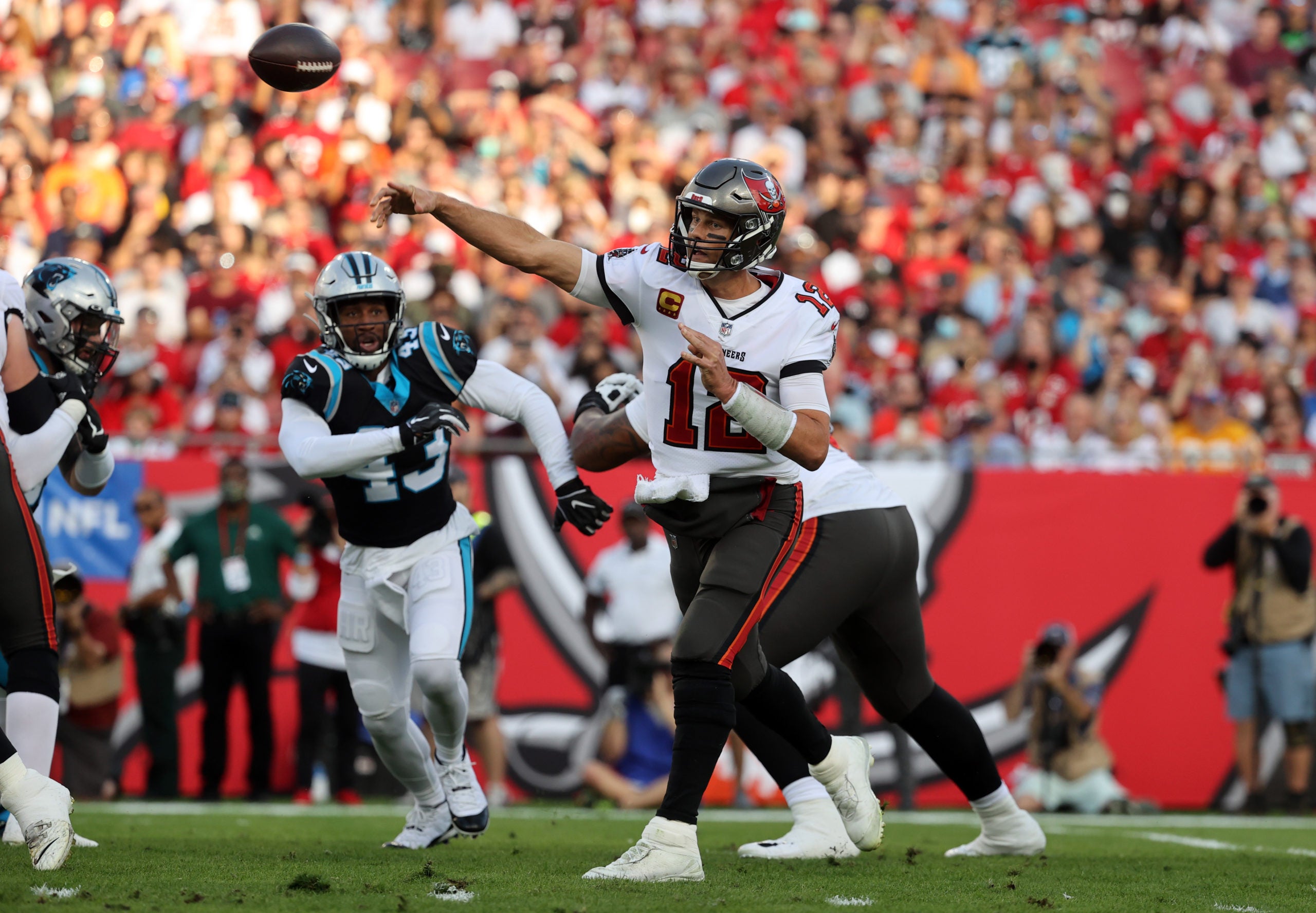 Jan 9, 2022; Tampa, Florida, USA; Tampa Bay Buccaneers quarterback Tom Brady (12) throws the ball against the Carolina Panthers during the first quarter at Raymond James Stadium. Mandatory Credit: Kim Klement-USA TODAY Sports