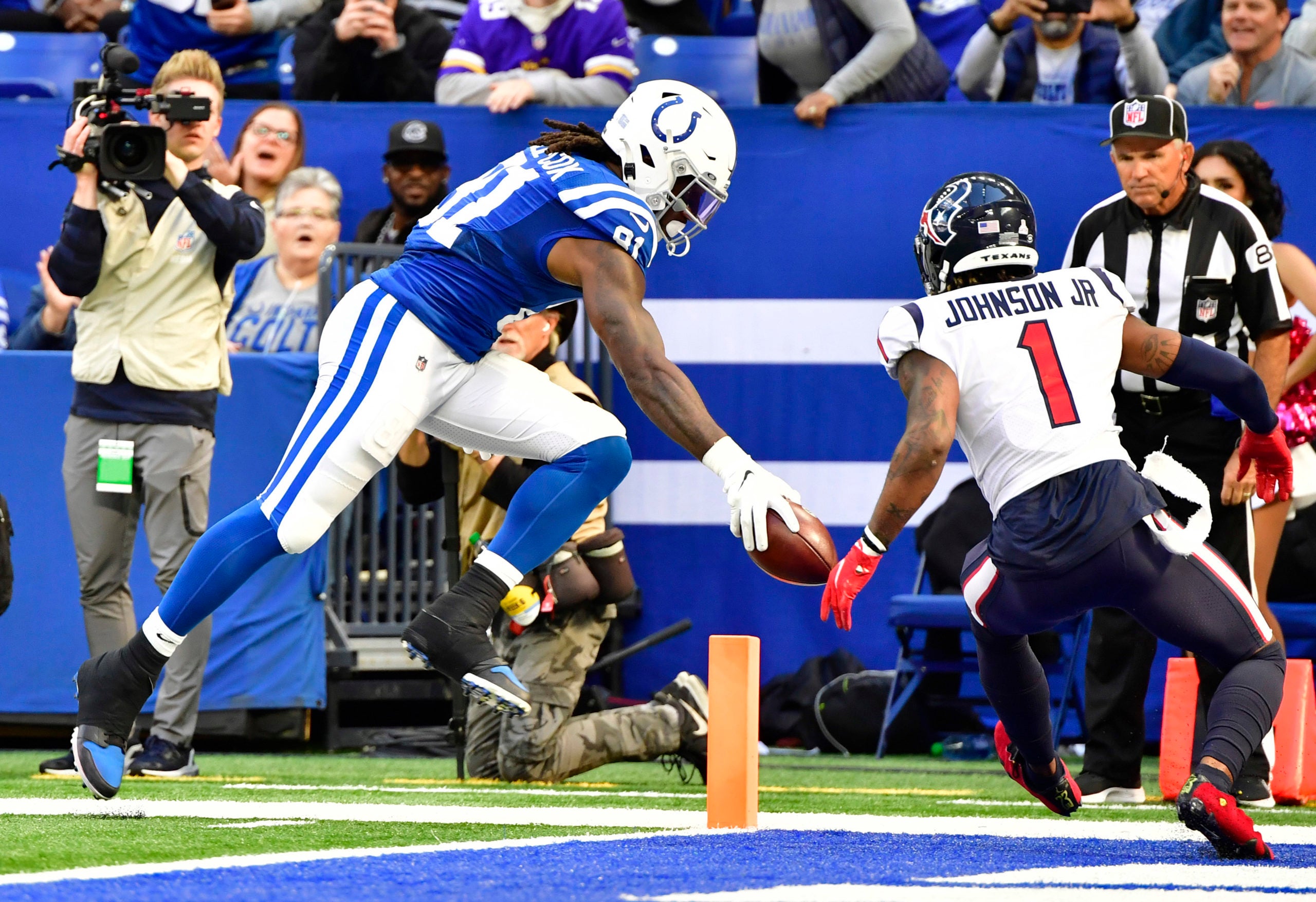 Oct 17, 2021; Indianapolis, Indiana, USA; Indianapolis Colts tight end Mo Alie-Cox (81) reacts the ball in for a touchdown in front of Houston Texans safety Lonnie Johnson (1) during the second half at Lucas Oil Stadium. The Colts win 31-3.  Mandatory Credit: Marc Lebryk-USA TODAY Sports