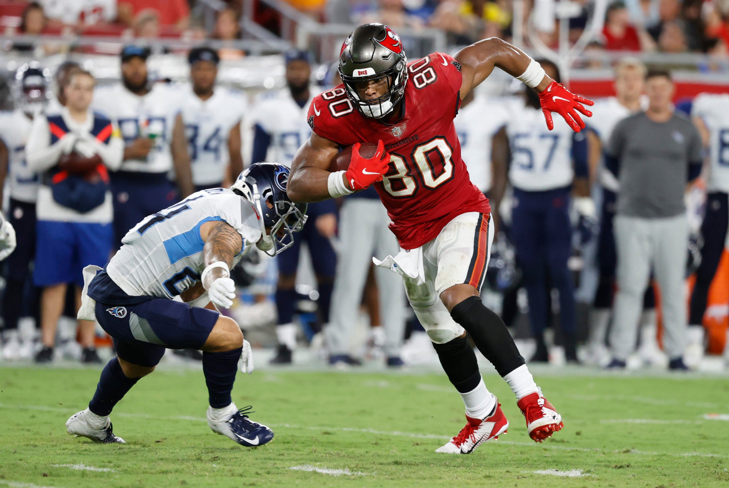Aug 21, 2021; Tampa, Florida, USA; Tampa Bay Buccaneers tight end O.J. Howard (80) runs the ball against Tennessee Titans cornerback Elijah Molden (24) during the second quarter at Raymond James Stadium. Mandatory Credit: Kim Klement-USA TODAY Sports