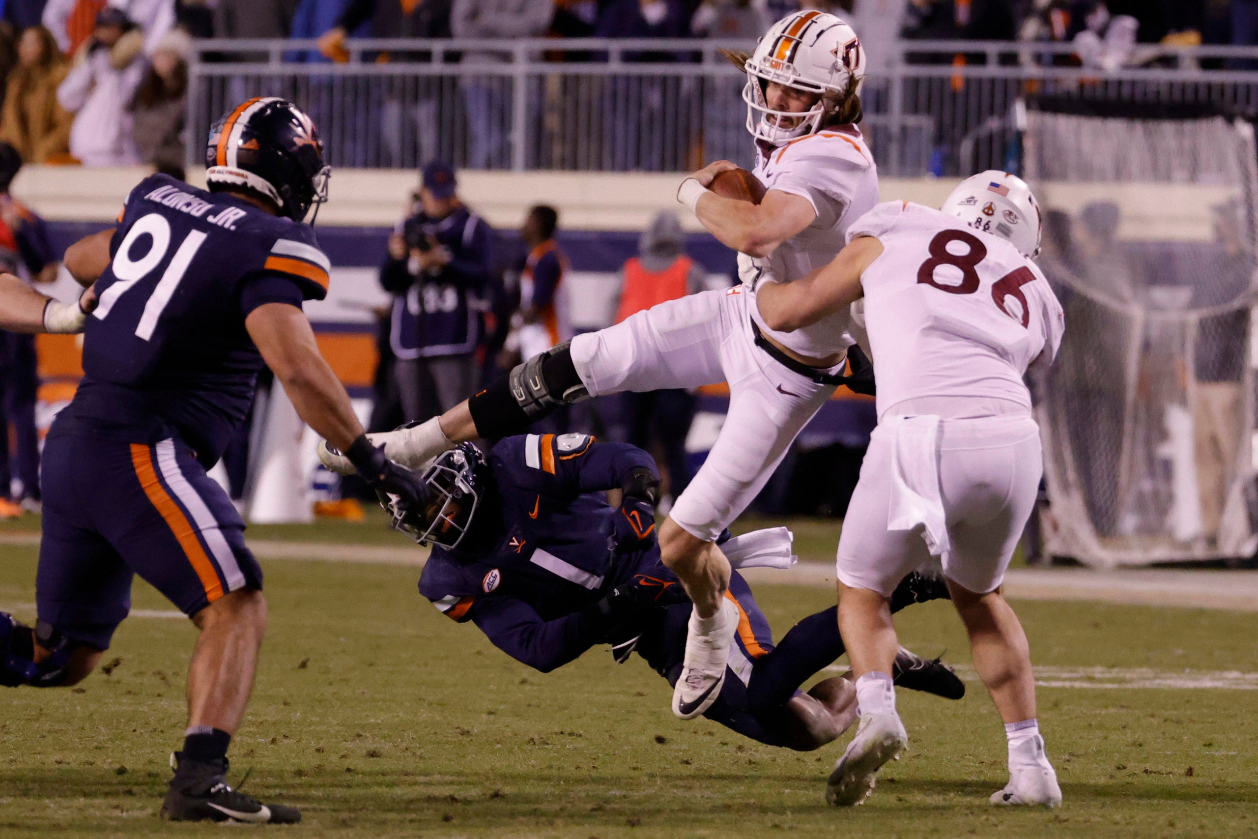 Nov 27, 2021; Charlottesville, Virginia, USA; Virginia Tech Hokies quarterback Connor Blumrick (4) fumbles the ball while bumping into Hokies tight end Nick Gallo (86) as Virginia Cavaliers cornerback Nick Grant (1) defends during the fourth quarter at Scott Stadium. Mandatory Credit: Geoff Burke-USA TODAY Sports