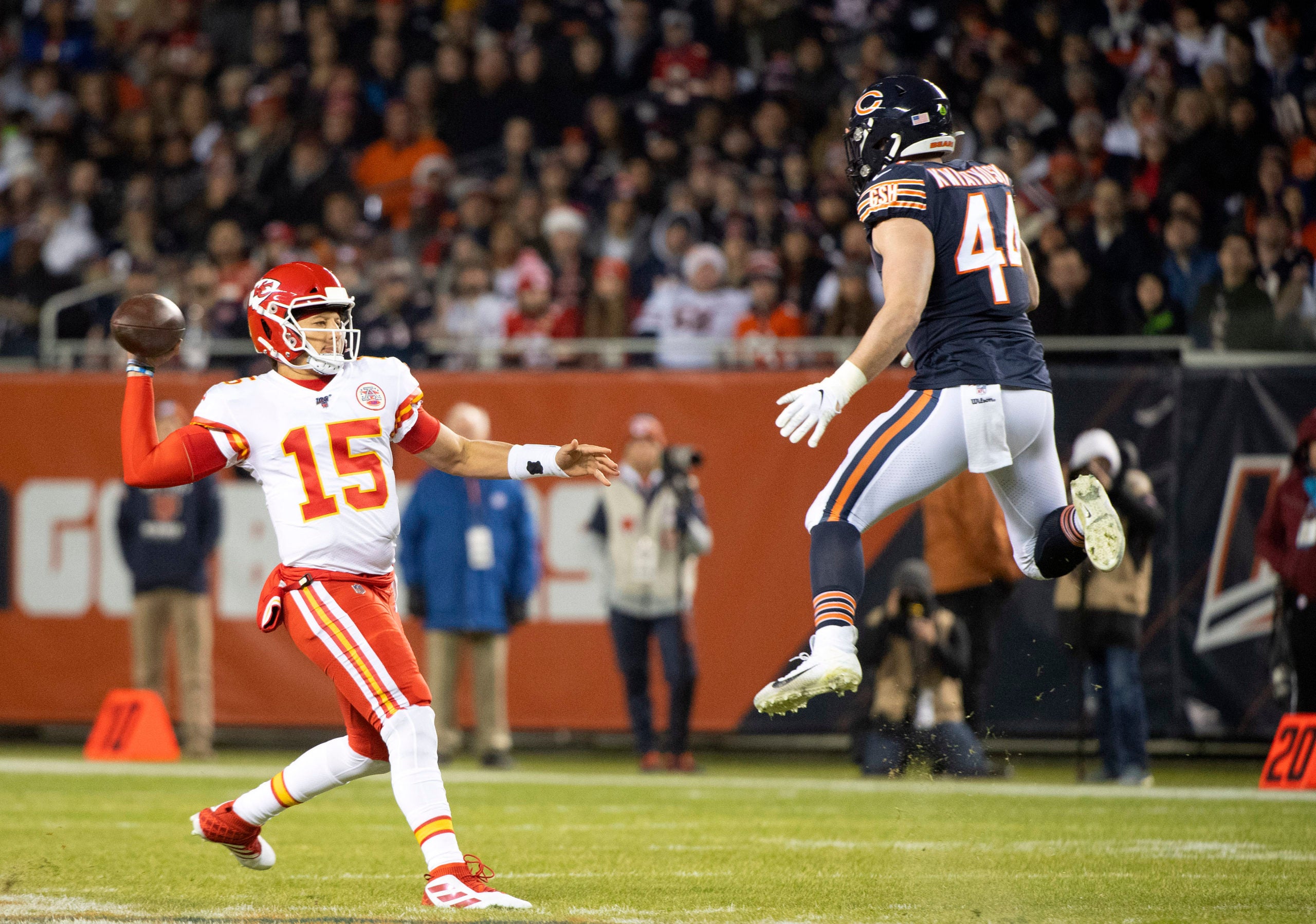 Dec 22, 2019; Chicago, Illinois, USA; Kansas City Chiefs quarterback Patrick Mahomes (15) rushes the ball against Chicago Bears inside linebacker Nick Kwiatkoski (44) during the first half at Soldier Field. Mandatory Credit: Mike Dinovo-USA TODAY Sports