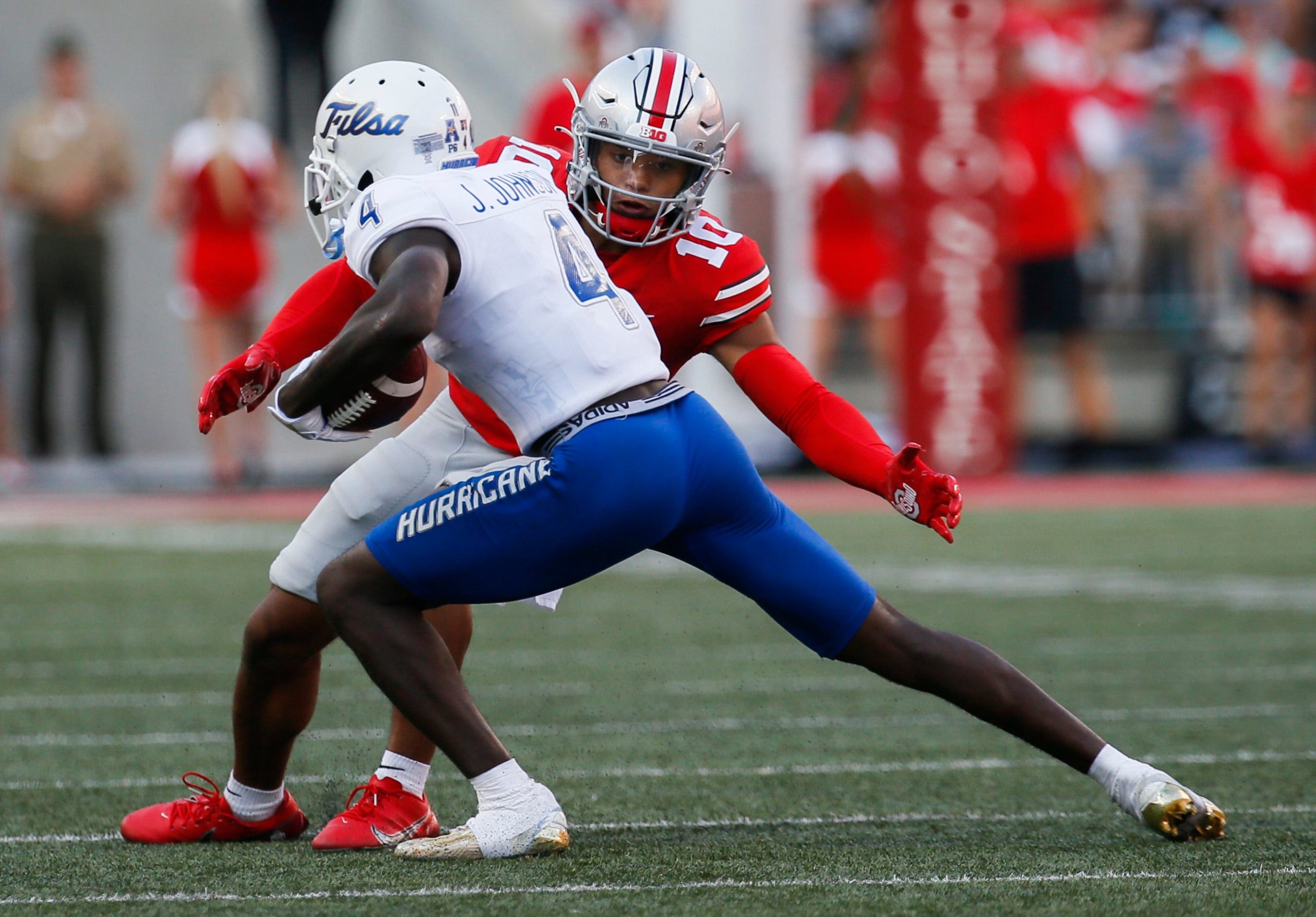Ohio State Buckeyes defensive back Cameron Martinez (10) misses a tackle as Tulsa Golden Hurricane wide receiver Josh Johnson (4) runs the ball during the third quarter of a NCAA Division I football game between the Ohio State Buckeyes and the Tulsa Golden Hurricane on Saturday, Sept. 18, 2021 at Ohio Stadium in Columbus, Ohio. Cfb Tulsa Golden Hurricane At Ohio State Buckeyes