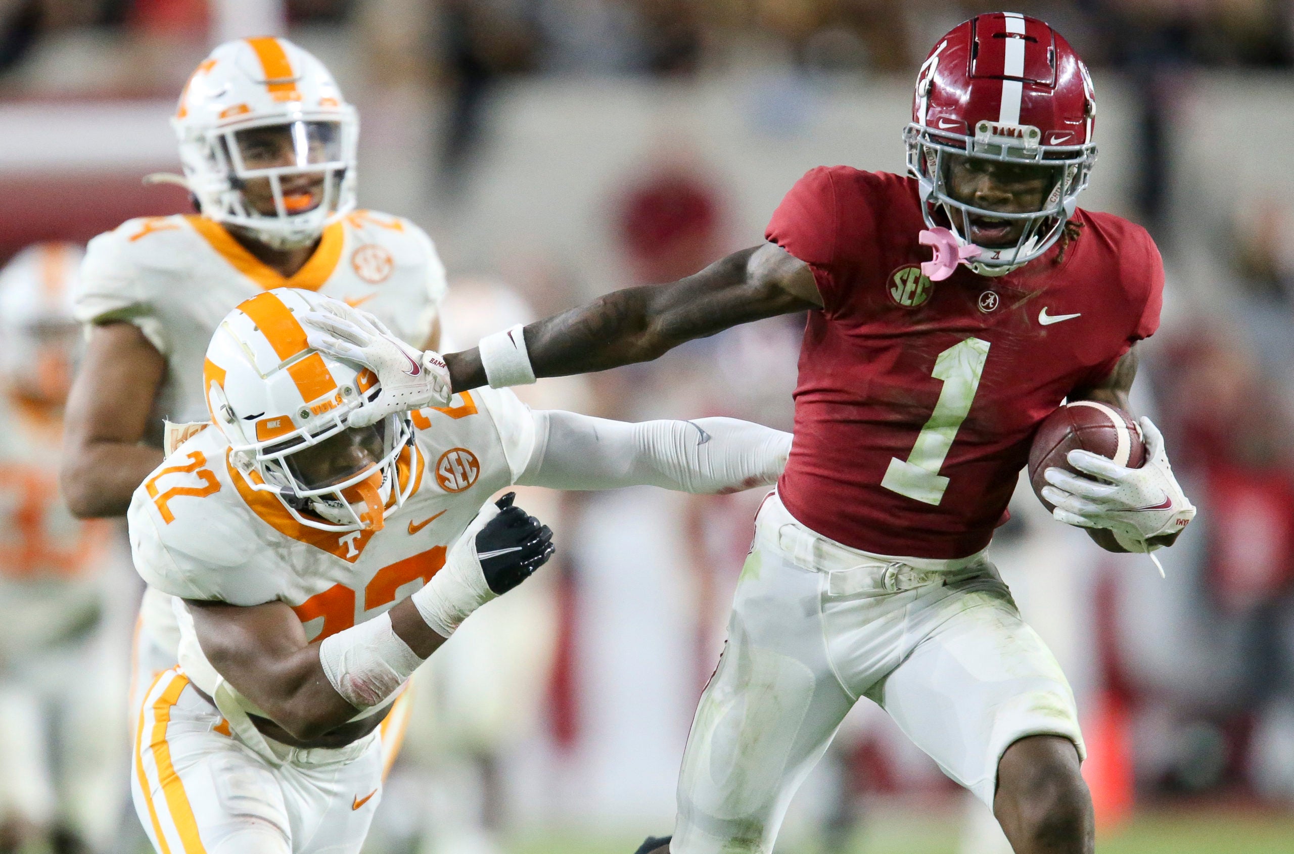 Oct 23, 2021; Tuscaloosa, Alabama, USA; Alabama Crimson Tide wide receiver Jameson Williams (1) uses a stiff arm to try to break away from Tennessee Volunteers defensive back Jaylen McCollough (22) at Bryant-Denny Stadium. Alabama won 52-24. Mandatory Credit: Gary Cosby Jr.-USA TODAY Sports