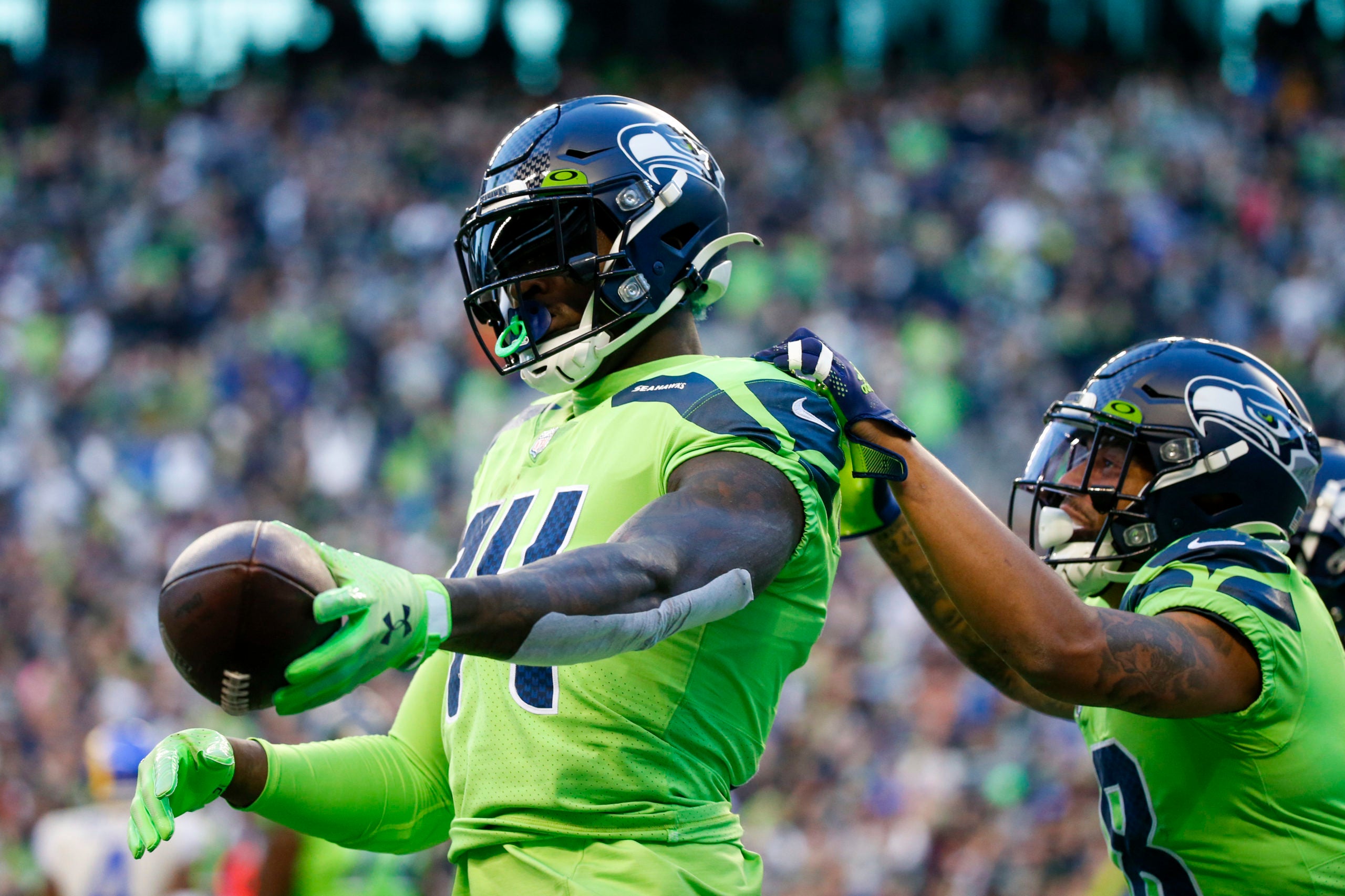 Oct 7, 2021; Seattle, Washington, USA; Seattle Seahawks wide receiver DK Metcalf (14) celebrates with wide receiver Freddie Swain (14) after catching a touchdown pass against the Los Angeles Rams during the second quarter at Lumen Field. Mandatory Credit: Joe Nicholson-USA TODAY Sports