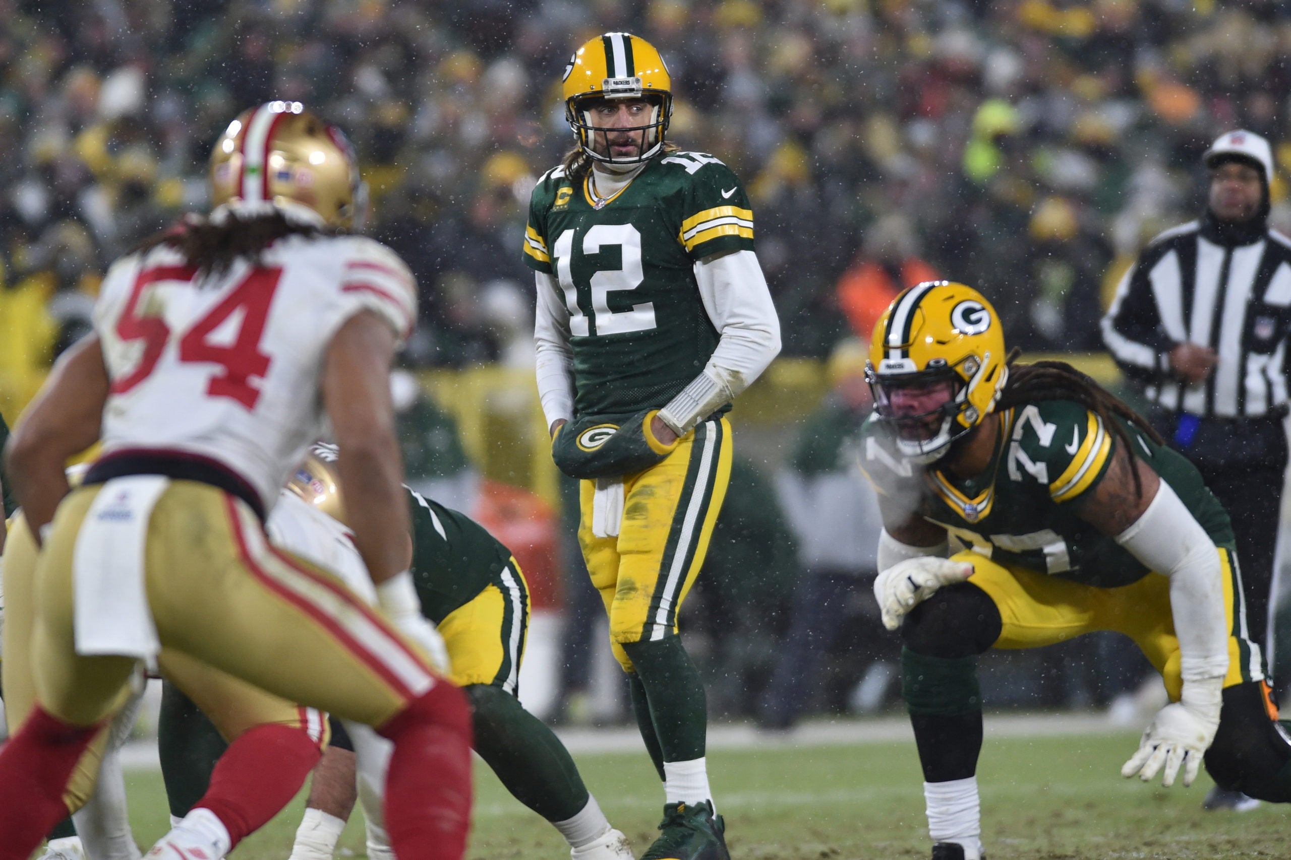 Jan 22, 2022; Green Bay, Wisconsin, USA; Green Bay Packers quarterback Aaron Rodgers (12) and offensive tackle Billy Turner (77) in action against the San Francisco 49ers during a NFC Divisional playoff football game at Lambeau Field. Mandatory Credit: Jeffrey Becker-USA TODAY Sports