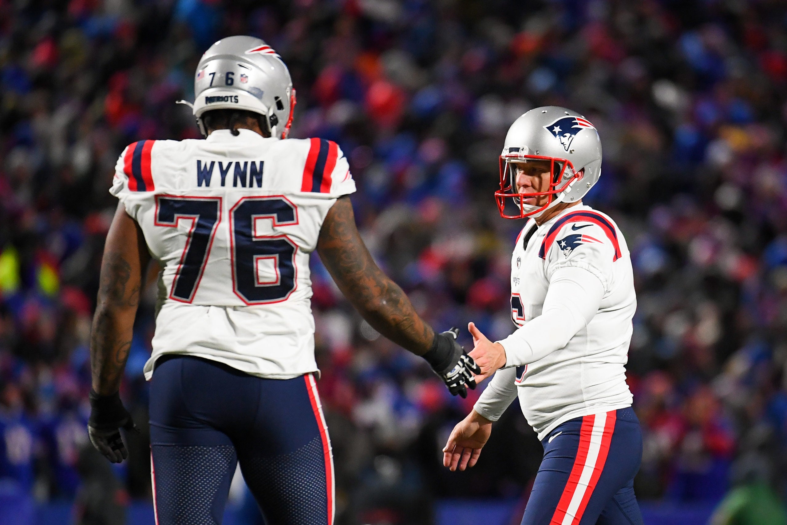 Dec 6, 2021; Orchard Park, New York, USA; New England Patriots kicker Nick Folk (right) celebrates a made field goal with teammate offensive tackle Isaiah Wynn (76) against the Buffalo Bills during the second half at Highmark Stadium. Mandatory Credit: Rich Barnes-USA TODAY Sports