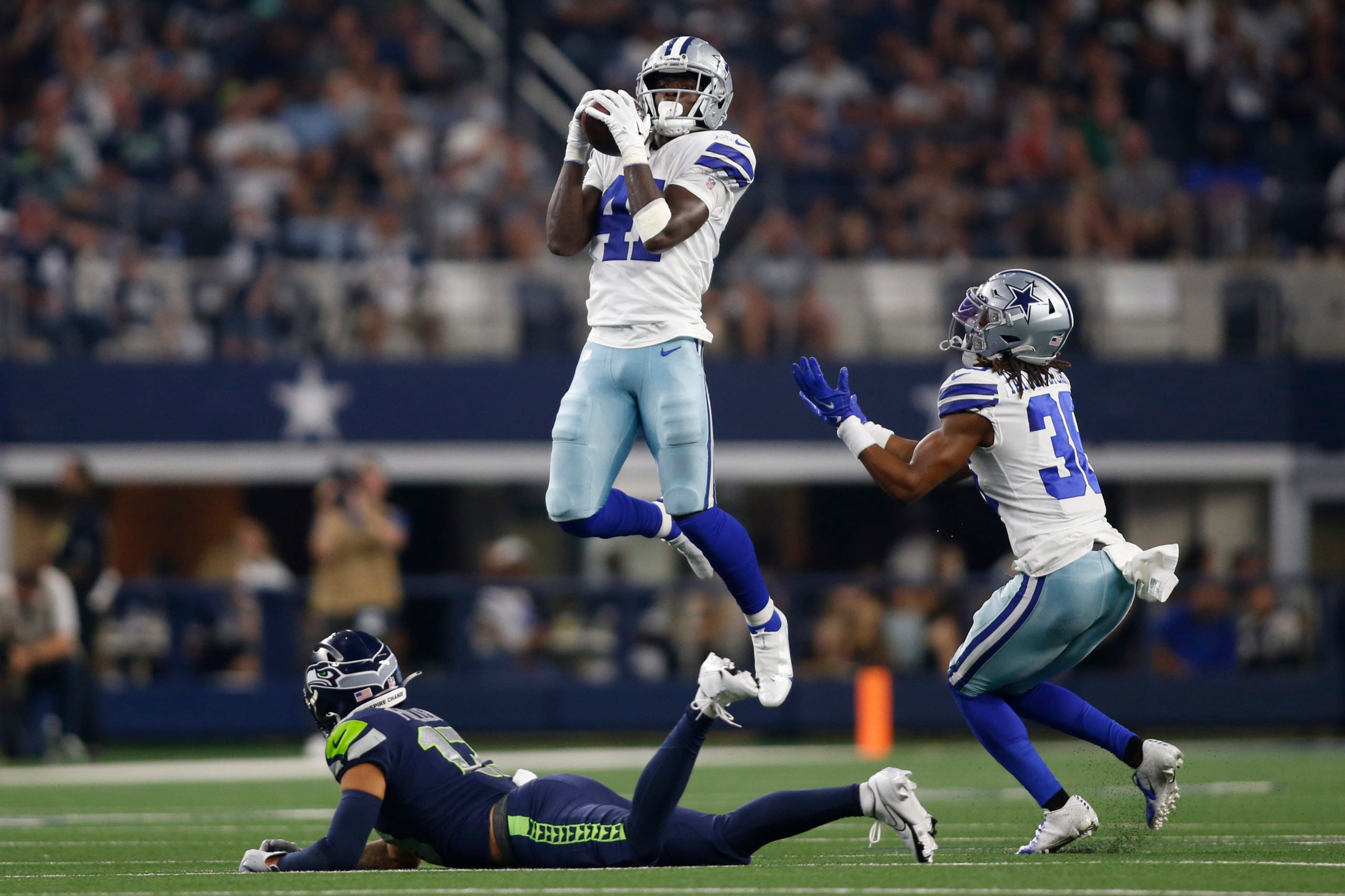 Aug 26, 2022; Arlington, Texas, USA; Dallas Cowboys safety Markquese Bell (41) intercepts a pass that bounced off Seattle Seahawks wide receiver Aaron Fuller (13) in the second half at AT&T Stadium. Mandatory Credit: Tim Heitman-USA TODAY Sports