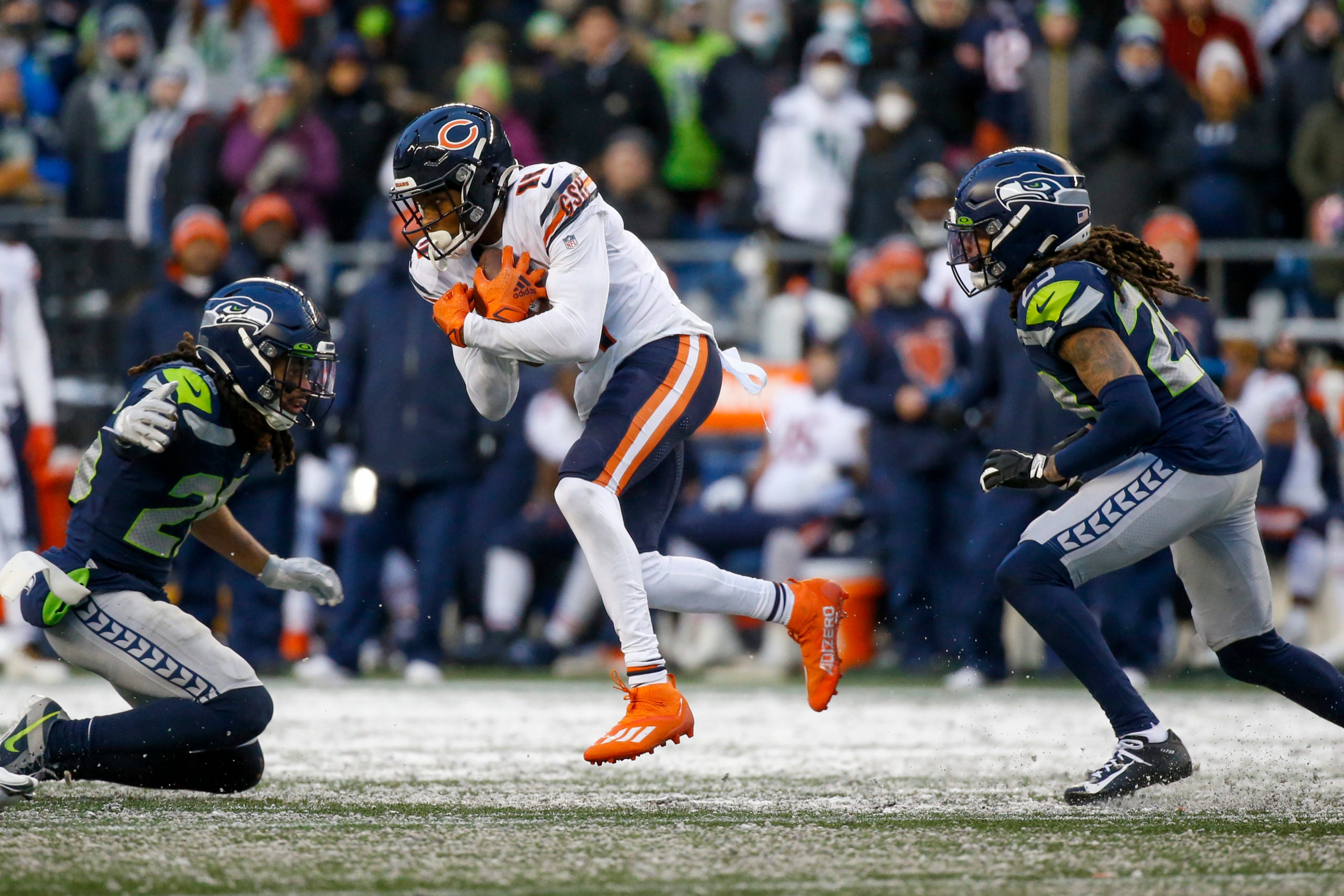 Dec 26, 2021; Seattle, Washington, USA; Chicago Bears wide receiver Darnell Mooney (11) runs for yards after the catch against Seattle Seahawks defensive back Ryan Neal (26, left) and cornerback Sidney Jones (23, right) during the fourth quarter at Lumen Field. Mandatory Credit: Joe Nicholson-USA TODAY Sports