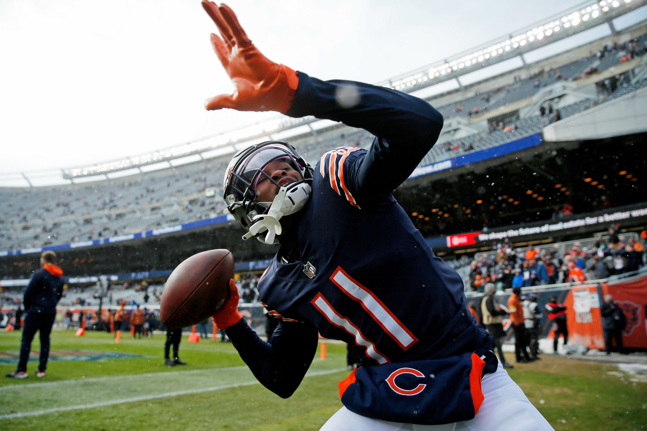 Jan 2, 2022; Chicago, Illinois, USA; Chicago Bears wide receiver Darnell Mooney (11) throws the ball into the stands as he plays catch with fans during warmups before the game against the New York Giants at Soldier Field. Mandatory Credit: Jon Durr-USA TODAY Sports