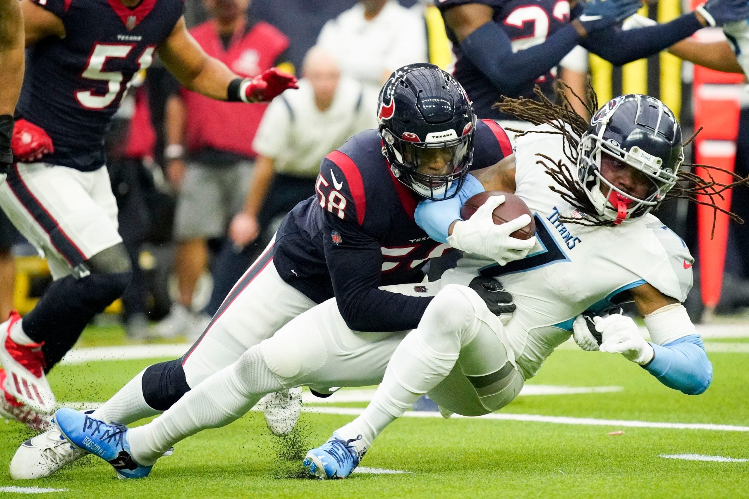 Jan 9, 2022; Houston, TX, USA;  Tennessee Titans running back D'onta Foreman (7) gets stopped by Houston Texans middle linebacker Christian Kirksey (58) during the first quarter at NRG Stadium. Mandatory Credit: George Walker IV-USA TODAY Sports