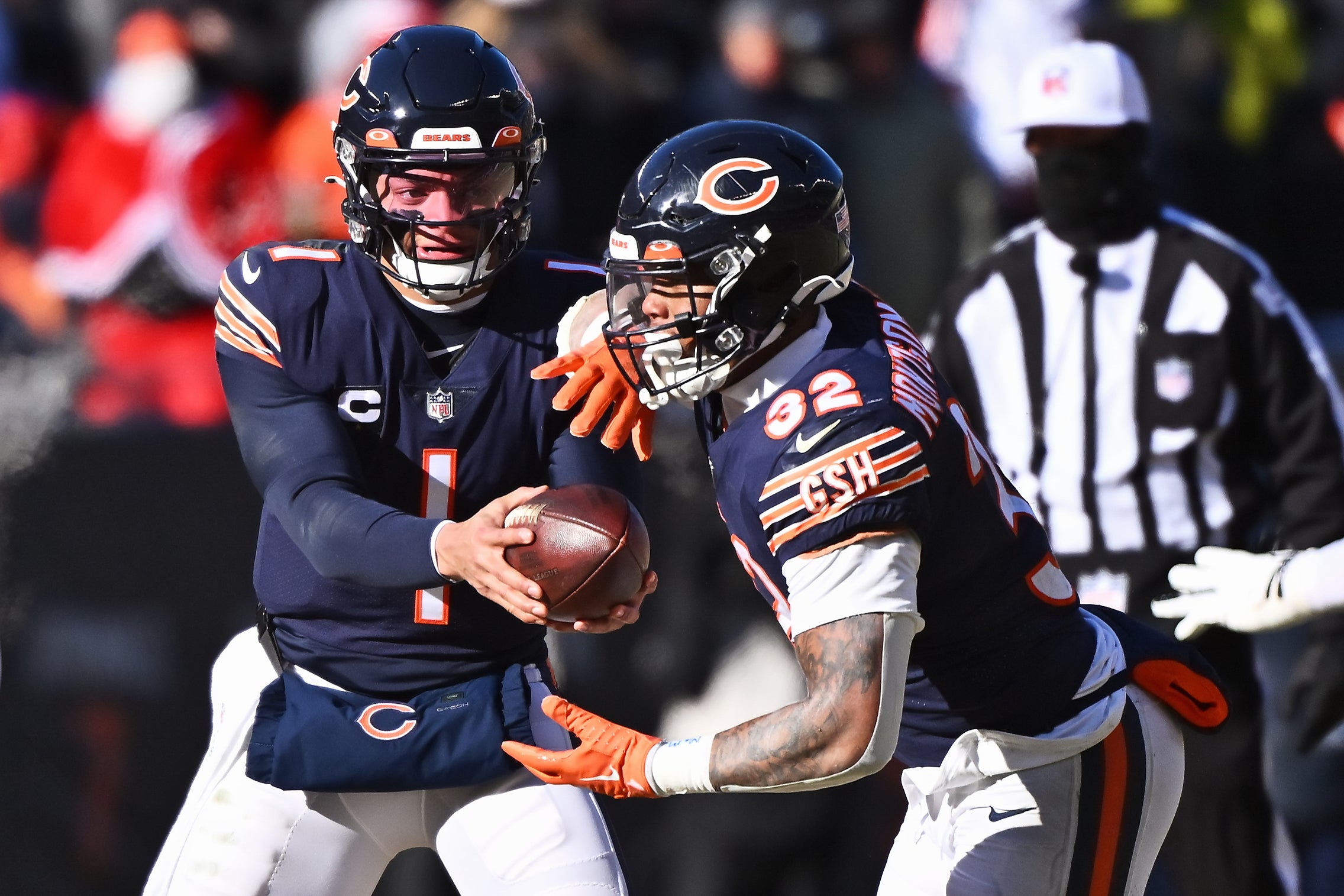 Dec 24, 2022; Chicago, Illinois, USA;  Chicago Bears quarterback Justin Fields (1) hands off the ball to running back David Montgomery (32) against the Buffalo Bills at Soldier Field. Mandatory Credit: Jamie Sabau-USA TODAY Sports
