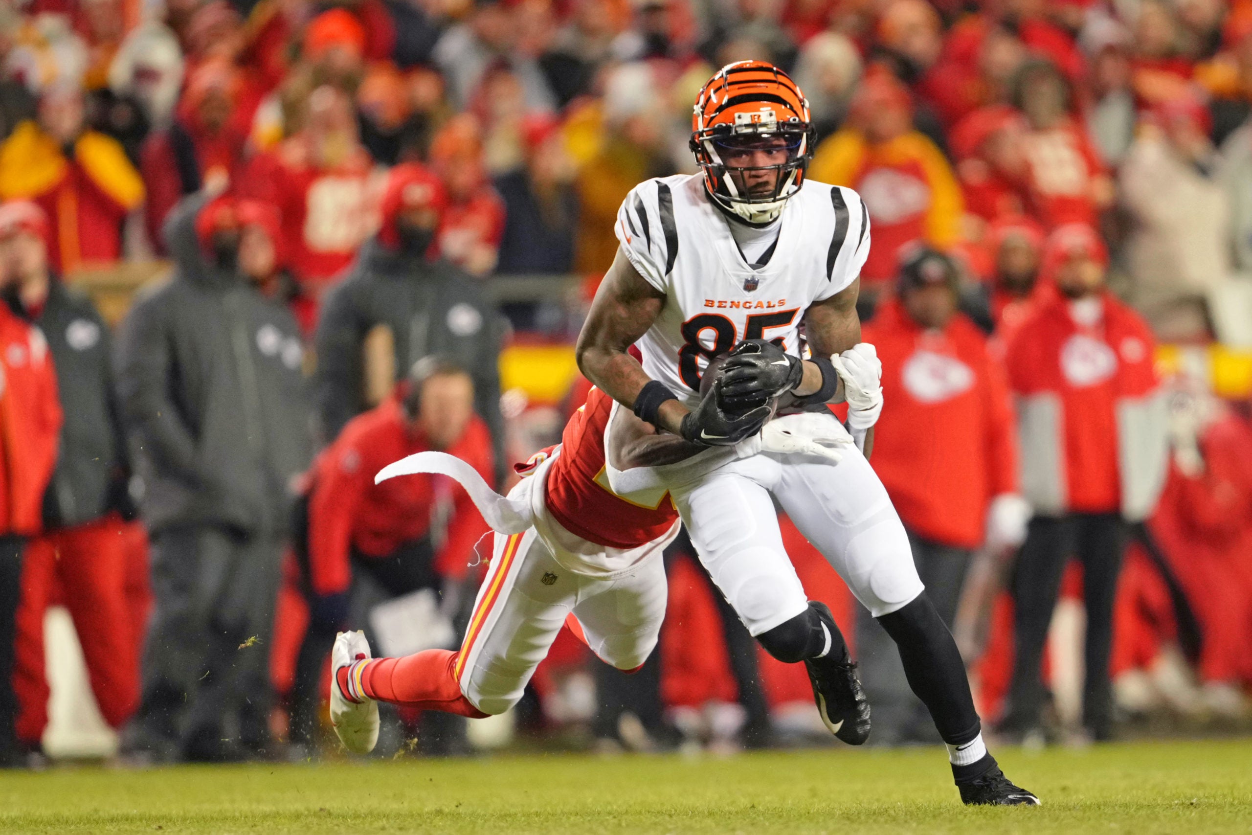 Jan 29, 2023; Kansas City, Missouri, USA; Cincinnati Bengals wide receiver Tee Higgins (85) makes a catch as Kansas City Chiefs cornerback Joshua Williams (23) defends during the second quarter of the AFC Championship game at GEHA Field at Arrowhead Stadium. Mandatory Credit: Jay Biggerstaff-USA TODAY Sports