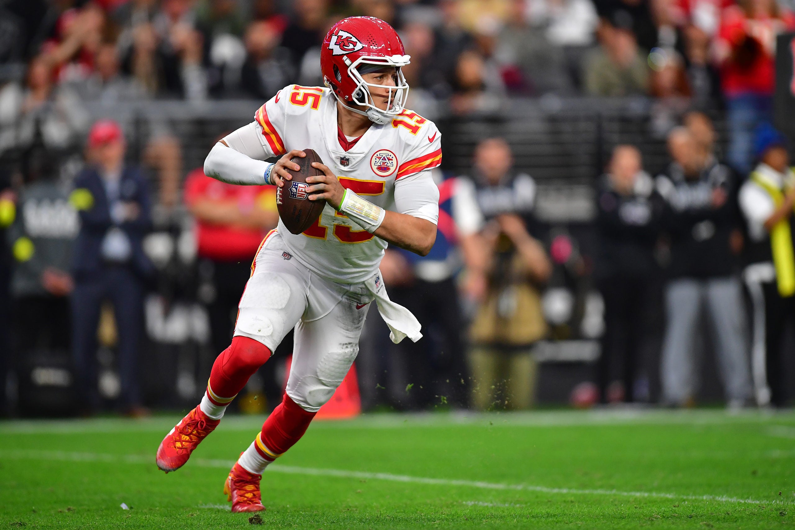 Jan 7, 2023; Paradise, Nevada, USA; Kansas City Chiefs quarterback Patrick Mahomes (15) moves out to pass against the Las Vegas Raiders during the first half at Allegiant Stadium. Mandatory Credit: Gary A. Vasquez-USA TODAY Sports