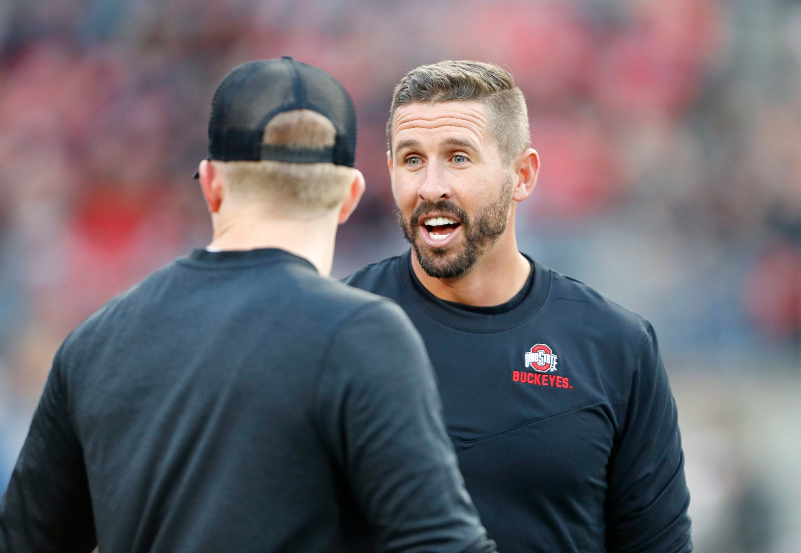 Sep 24, 2022; Columbus, Ohio, USA;  Ohio State Buckeyes assistant coach Brian Hartline talks with coaches before the game against the Wisconsin Badgers at Ohio Stadium. Mandatory Credit: Joseph Maiorana-USA TODAY Sports