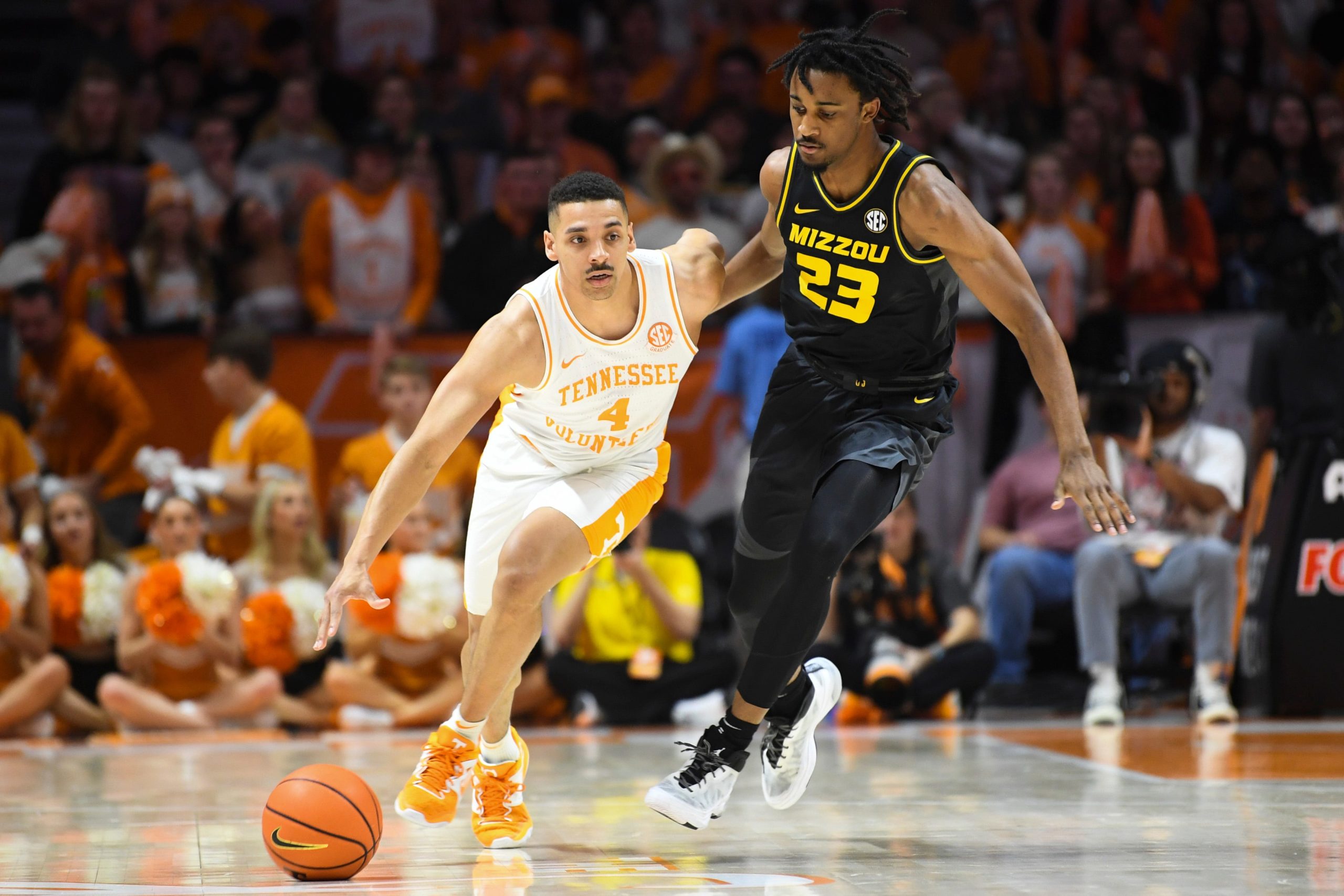 Tennessee guard Tyreke Key (4) dribbles toward the basket while defended by Missouri forward Aidan Shaw (23) during an NCAA college basketball game between the Missouri Tigers and the Tennessee Volunteers in Thompson-Boling Arena in Knoxville, Saturday Feb. 11, 2023. Tennesseemissouri0211 0564