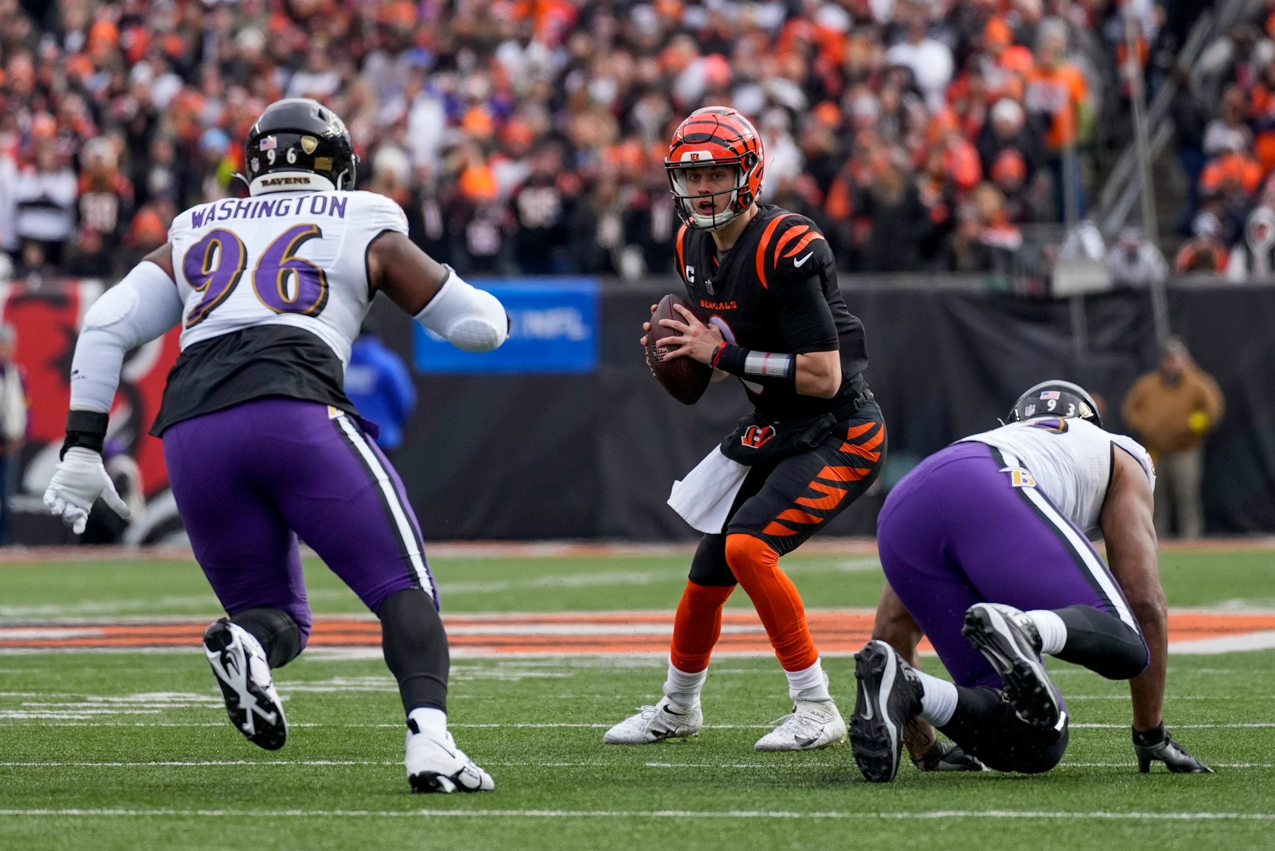 Cincinnati Bengals quarterback Joe Burrow (9) scrambles under pressure in the first quarter of the NFL Week 18 game between the Cincinnati Bengals and the Baltimore Ravens at Paycor Stadium in downtown Cincinnati on Sunday, Jan. 8, 2023. The Bengals led 24-7 at halftime. Baltimore Ravens At Cincinnati Bengals Nfl Week 18