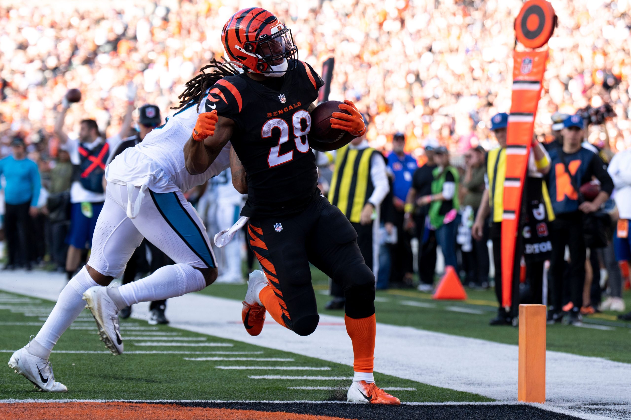Cincinnati Bengals running back Joe Mixon (28) scores his fifth touchdown as Carolina Panthers linebacker Shaq Thompson (7) attempts to stop him in the third quarter during a Week 9 NFL game, Sunday, Nov. 6, 2022, at Paycor Stadium in Cincinnati. Cincinnati Bengals running back Joe Mixon (28) scored a franchise record five touchdowns in the game. Nfl Carolina Panthers At Cincinnati Bengals
