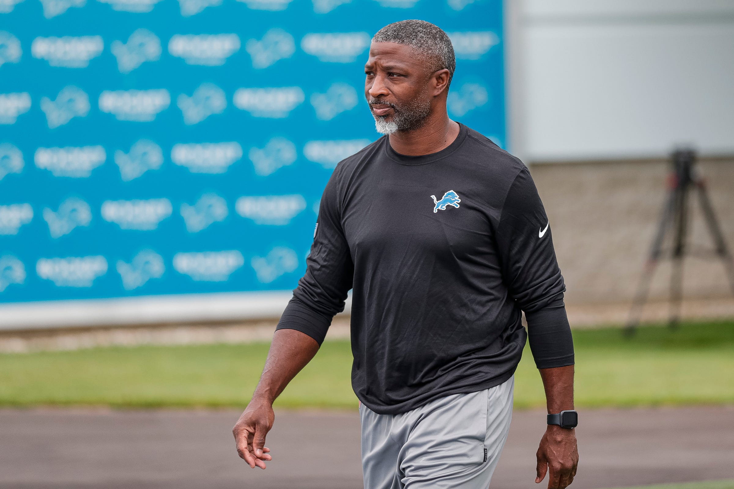 Lions defensive coordinator Aaron Glenn takes the field for practice during the first day of training camp July 27, 2022 in Allen Park.