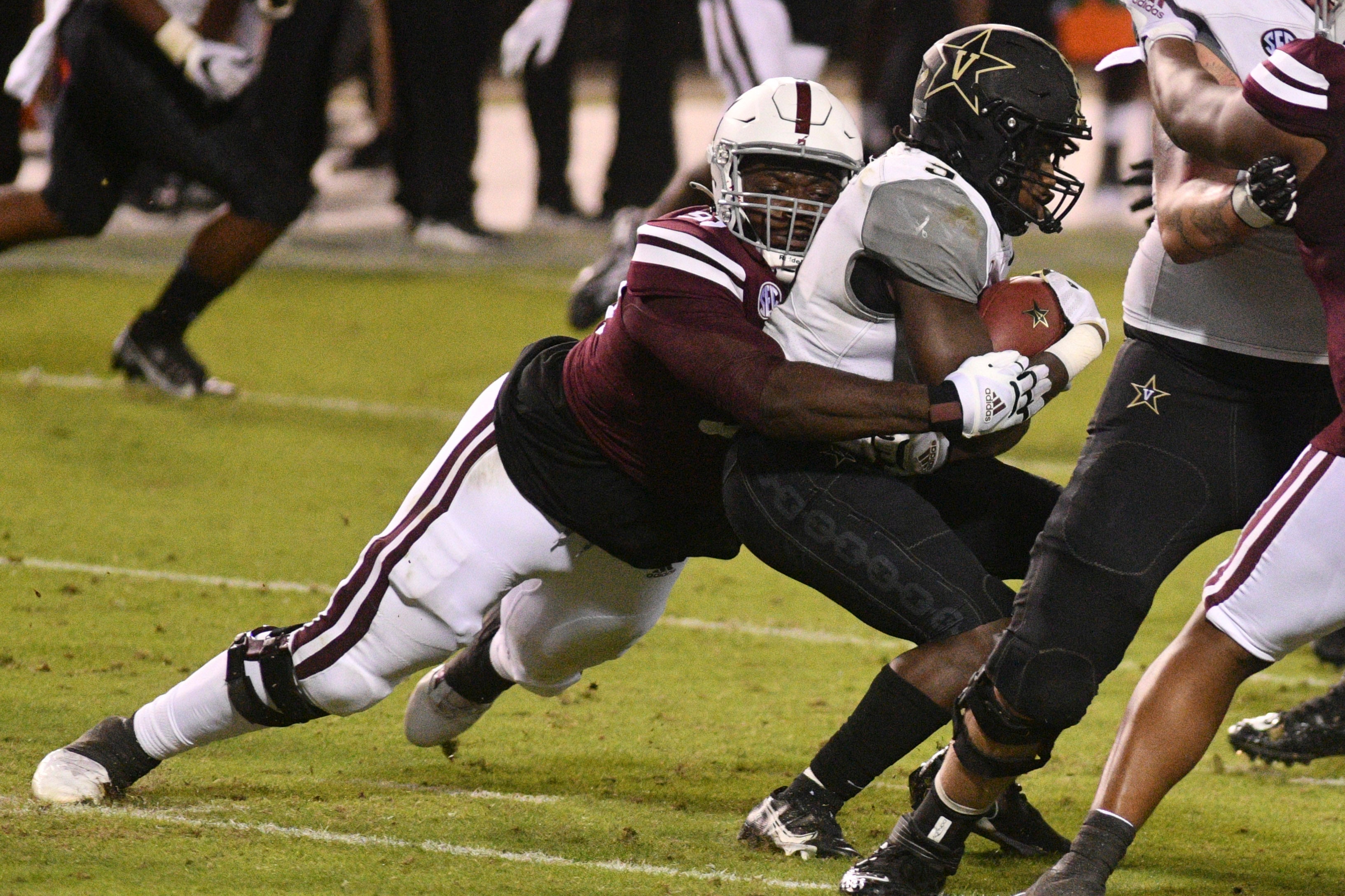 Nov 7, 2020; Starkville, Mississippi, USA; Mississippi State Bulldogs defensive tackle Cameron Young (L) tackles Vanderbilt Commodores running back Rocko Griffin (9) during the fourth quarter at Davis Wade Stadium at Scott Field.
