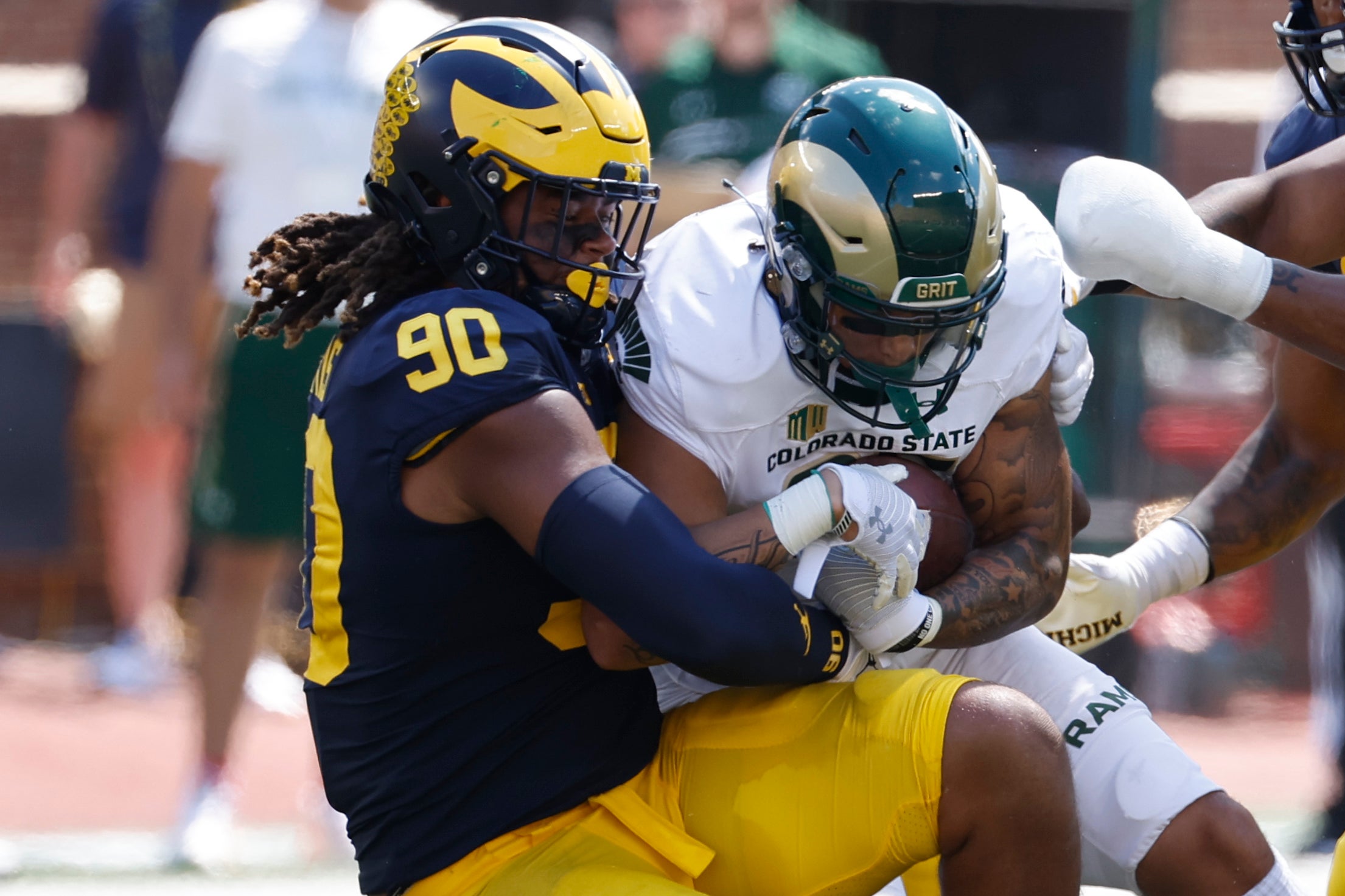 Sep 3, 2022; Ann Arbor, Michigan, USA; Michigan Wolverines linebacker Mike Morris (90) tackles Colorado State Rams running back Avery Morrow (25) in the first half at Michigan Stadium.