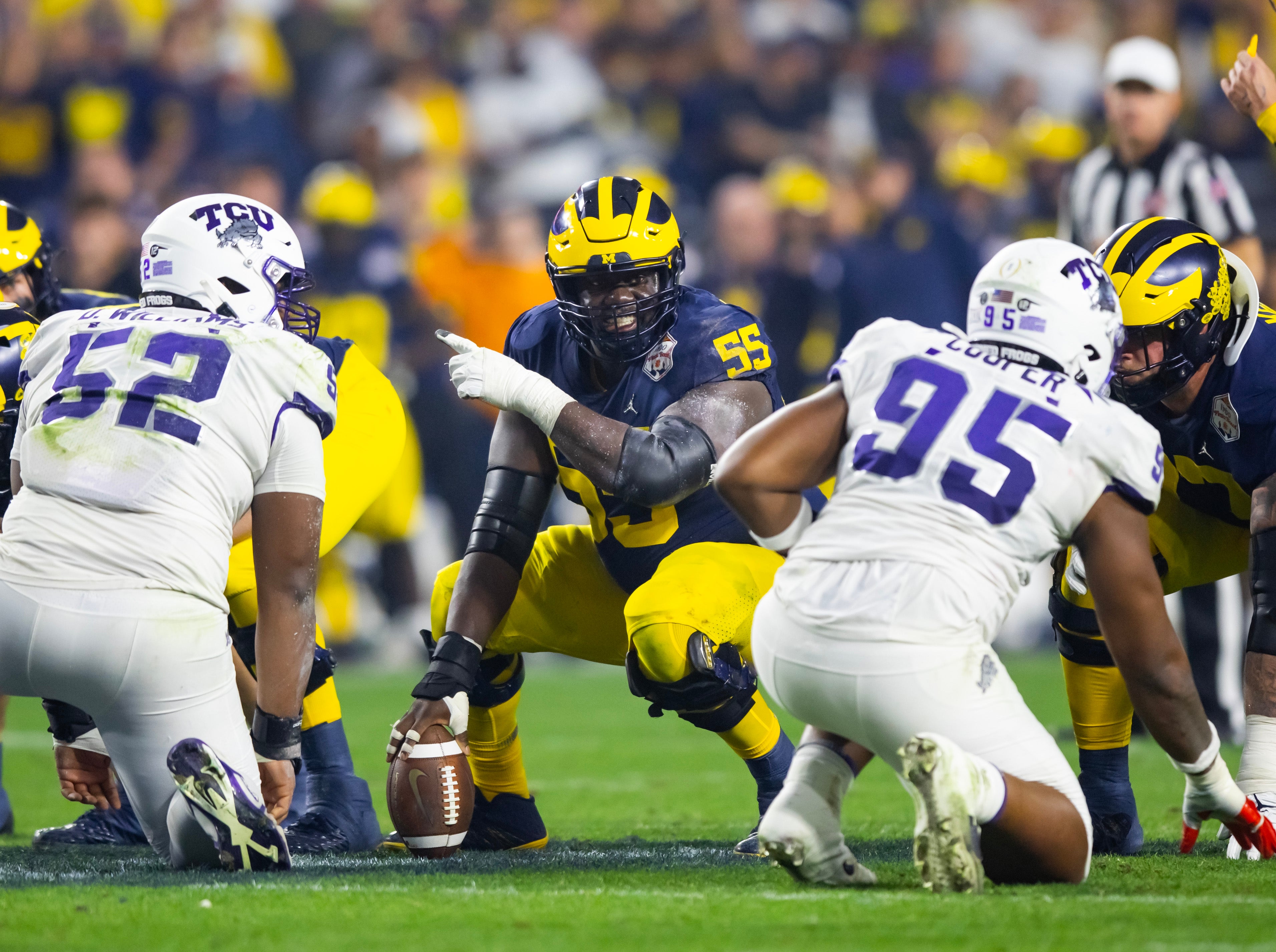 Dec 31, 2022; Glendale, Arizona, USA; Michigan Wolverines offensive lineman Olusegun Oluwatimi (55) against the TCU Horned Frogs during the 2022 Fiesta Bowl at State Farm Stadium.