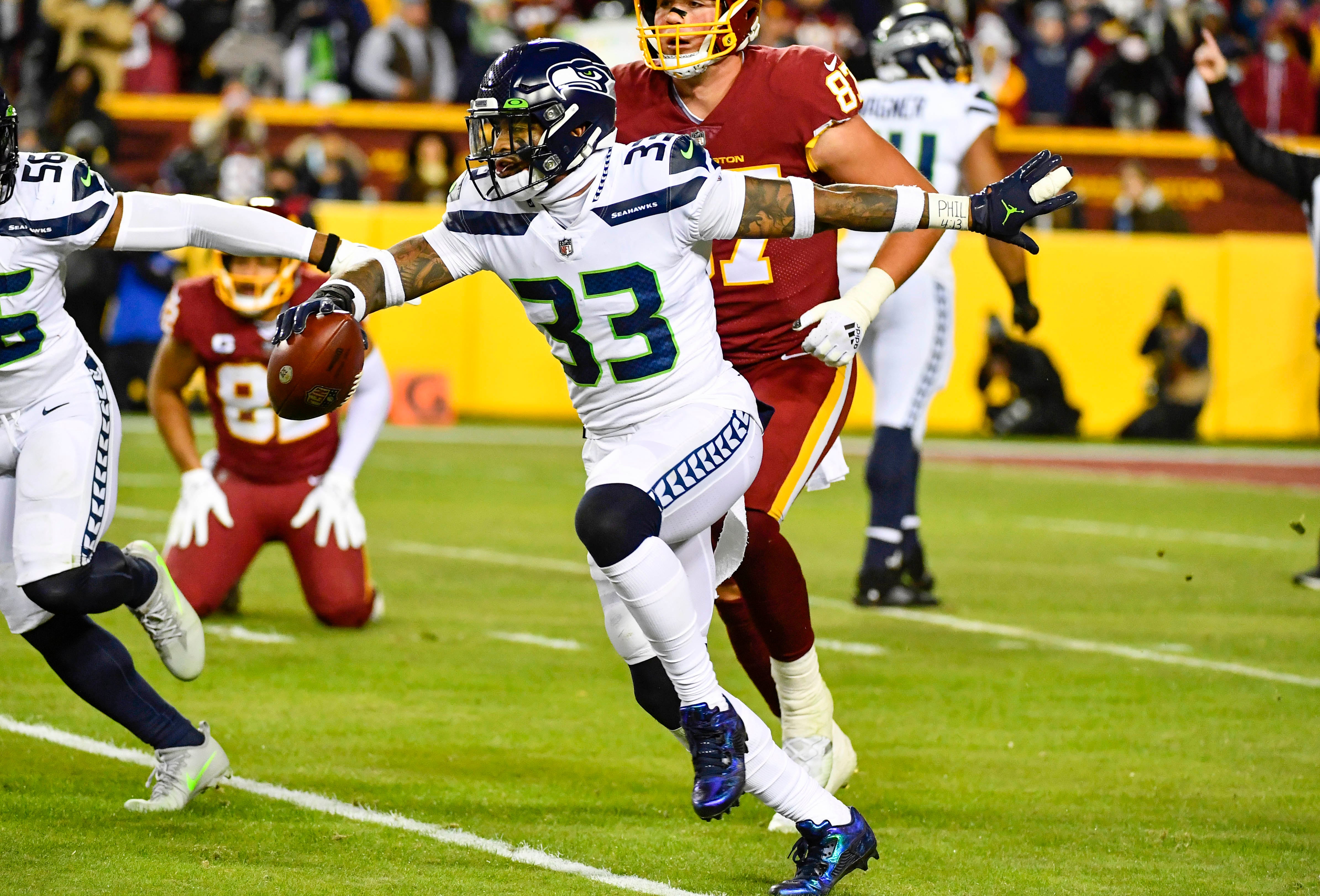 Nov 29, 2021; Landover, Maryland, USA; Seattle Seahawks safety Jamal Adams (33) reacts after recording an interception against the Washington Football Team during the first half at FedExField.