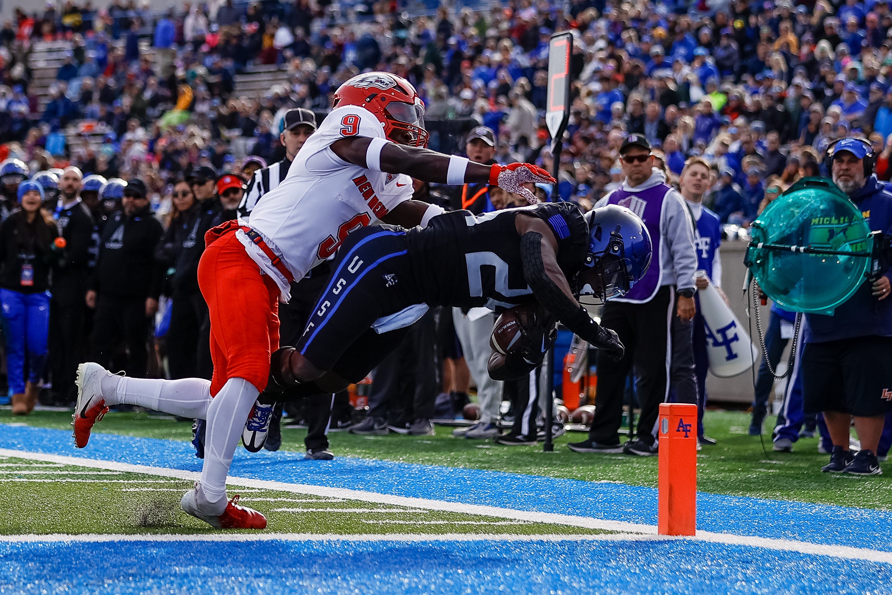 Nov 12, 2022; Colorado Springs, Colorado, USA; Air Force Falcons running back John Lee Eldridge III (24) dives for a touchdown against New Mexico Lobos safety Jerrick Reed II (9) in the first quarter at Falcon Stadium.