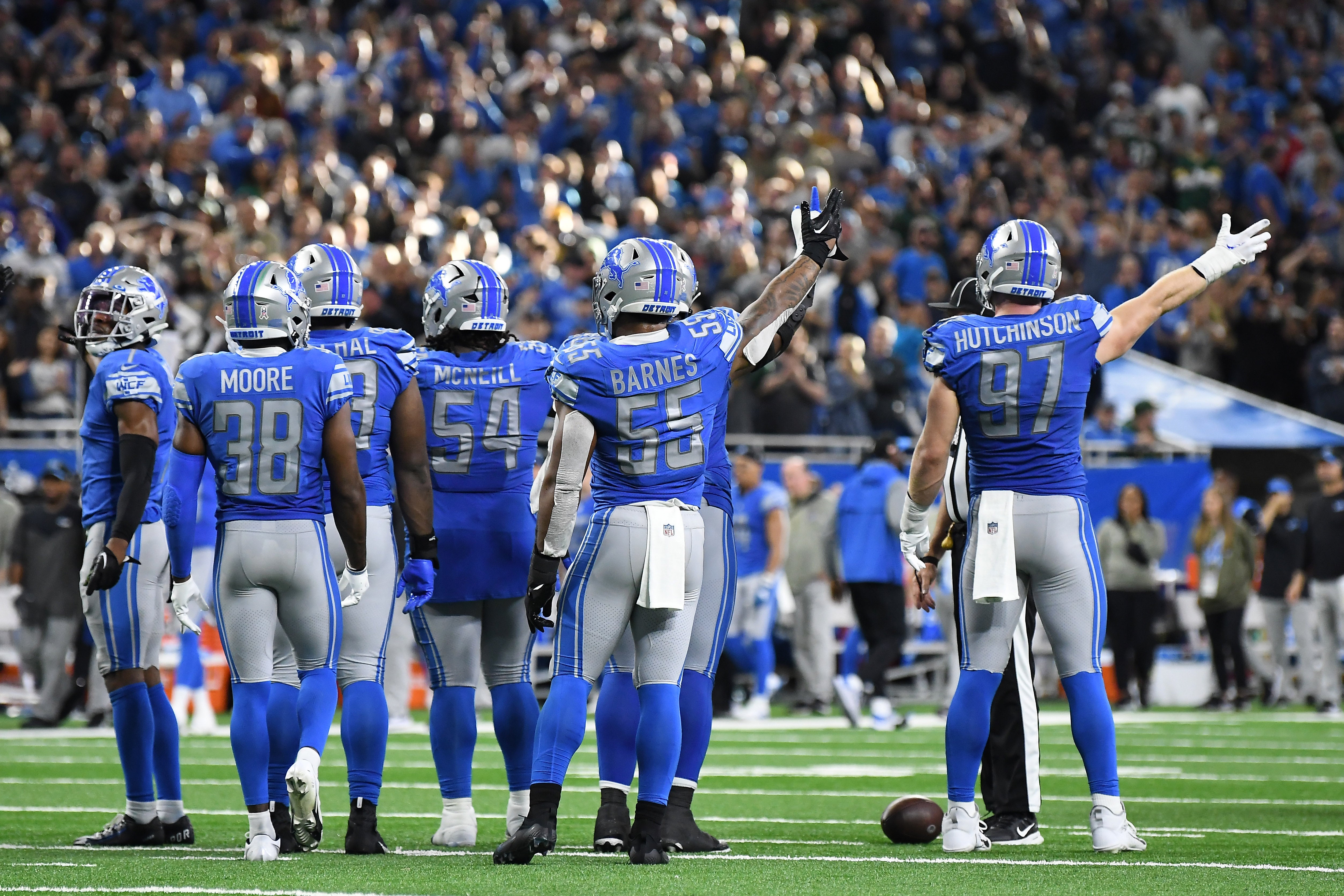 Nov 6, 2022; Detroit, Michigan, USA; The Detroit Lions defense signal that it should be their ball while watching a replay of a fumble along the sidelines against the Green Bay Packers late in the fourth quarter at Ford Field. Mandatory Credit: Lon Horwedel-USA TODAY Sports