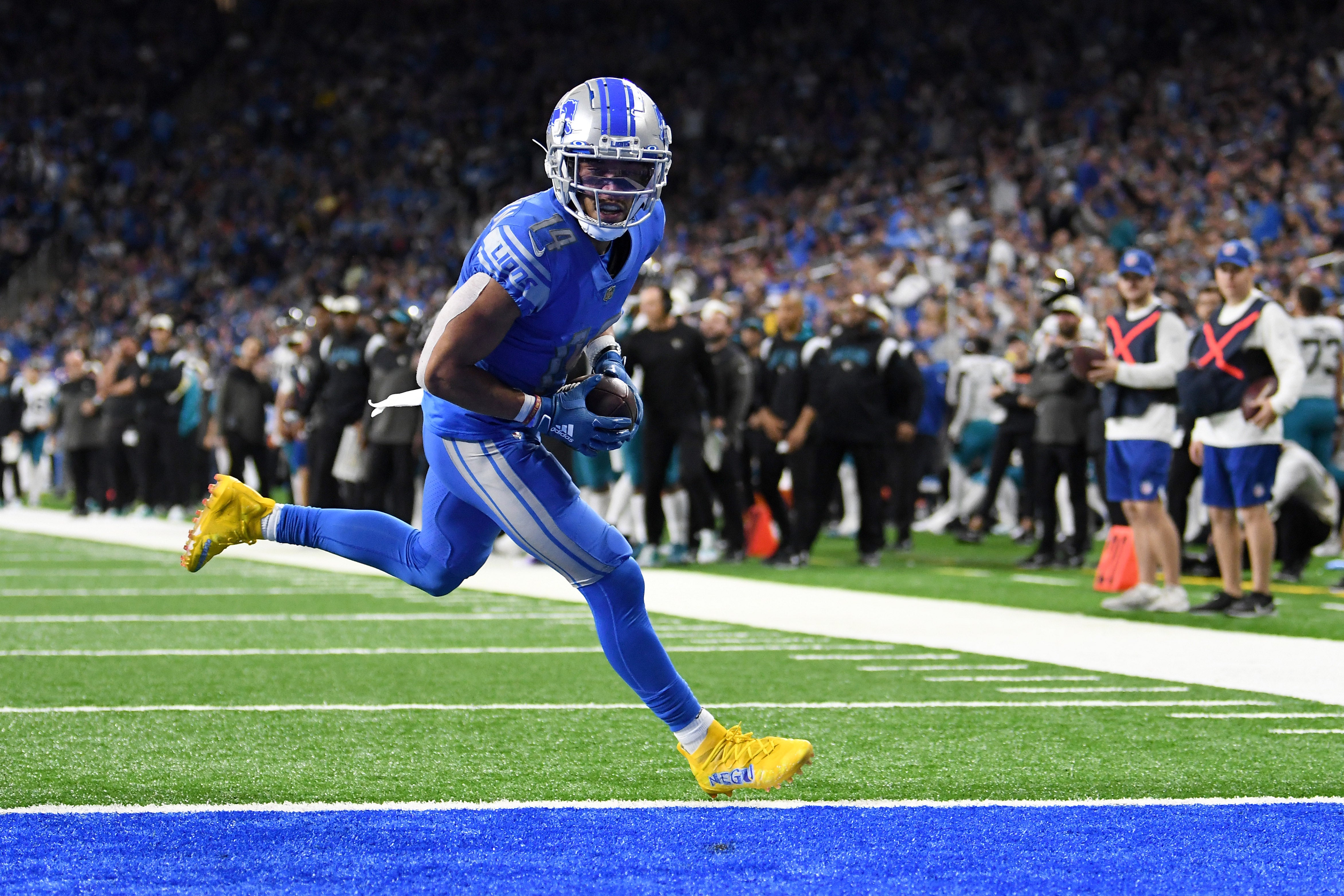 Dec 4, 2022; Detroit, Michigan, USA; Detroit Lions wide receiver Amon-Ra St. Brown (14) scores a touchdown after catching a pass from quarterback Jared Goff (not pictured) against the Jacksonville Jaguars in the fourth quarter at Ford Field. Mandatory Credit: Lon Horwedel-USA TODAY Sports