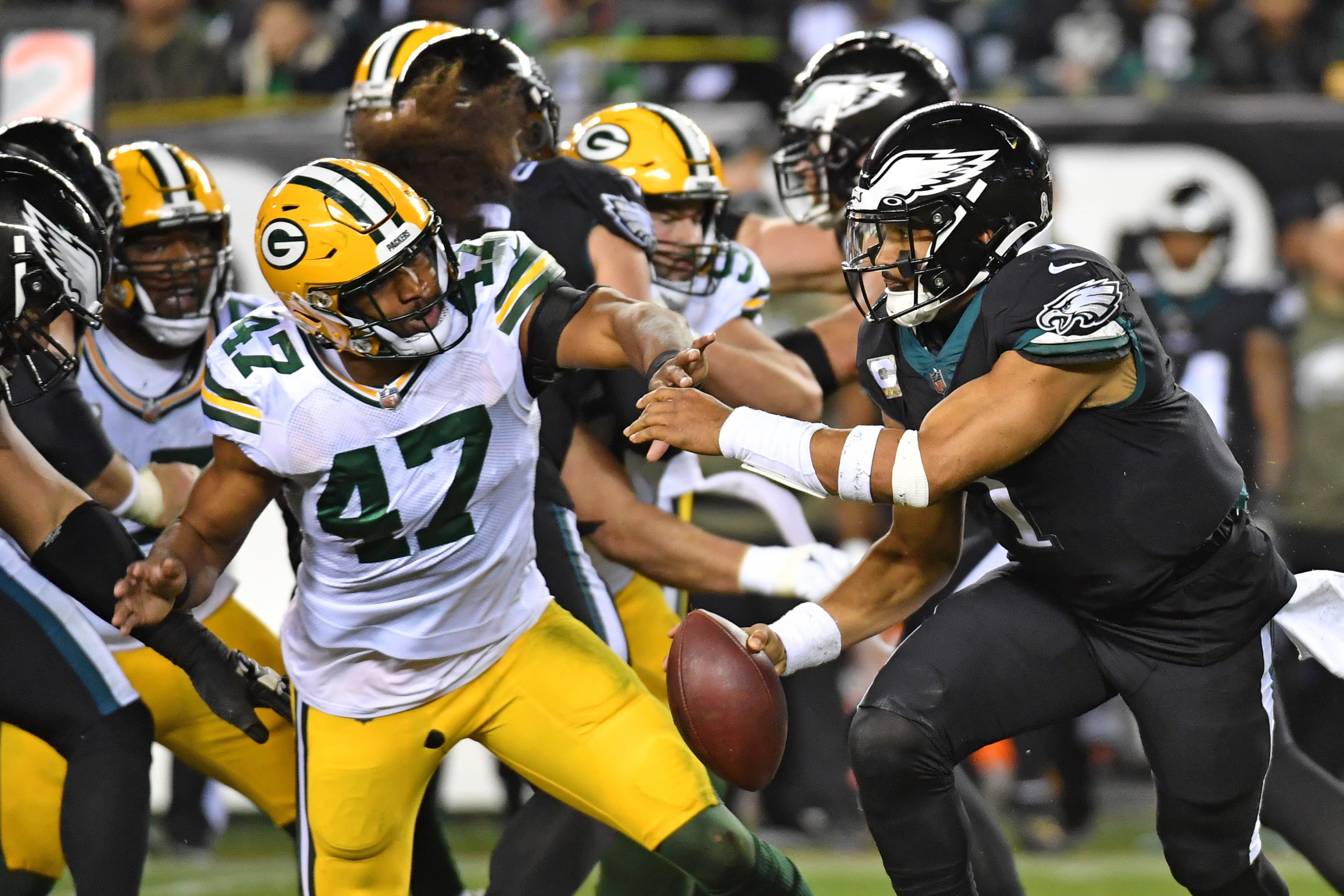 Nov 27, 2022; Philadelphia, Pennsylvania, USA; Philadelphia Eagles quarterback Jalen Hurts (1) is pressured by Green Bay Packers linebacker Justin Hollins (47) at Lincoln Financial Field. Mandatory Credit: Eric Hartline-USA TODAY Sports