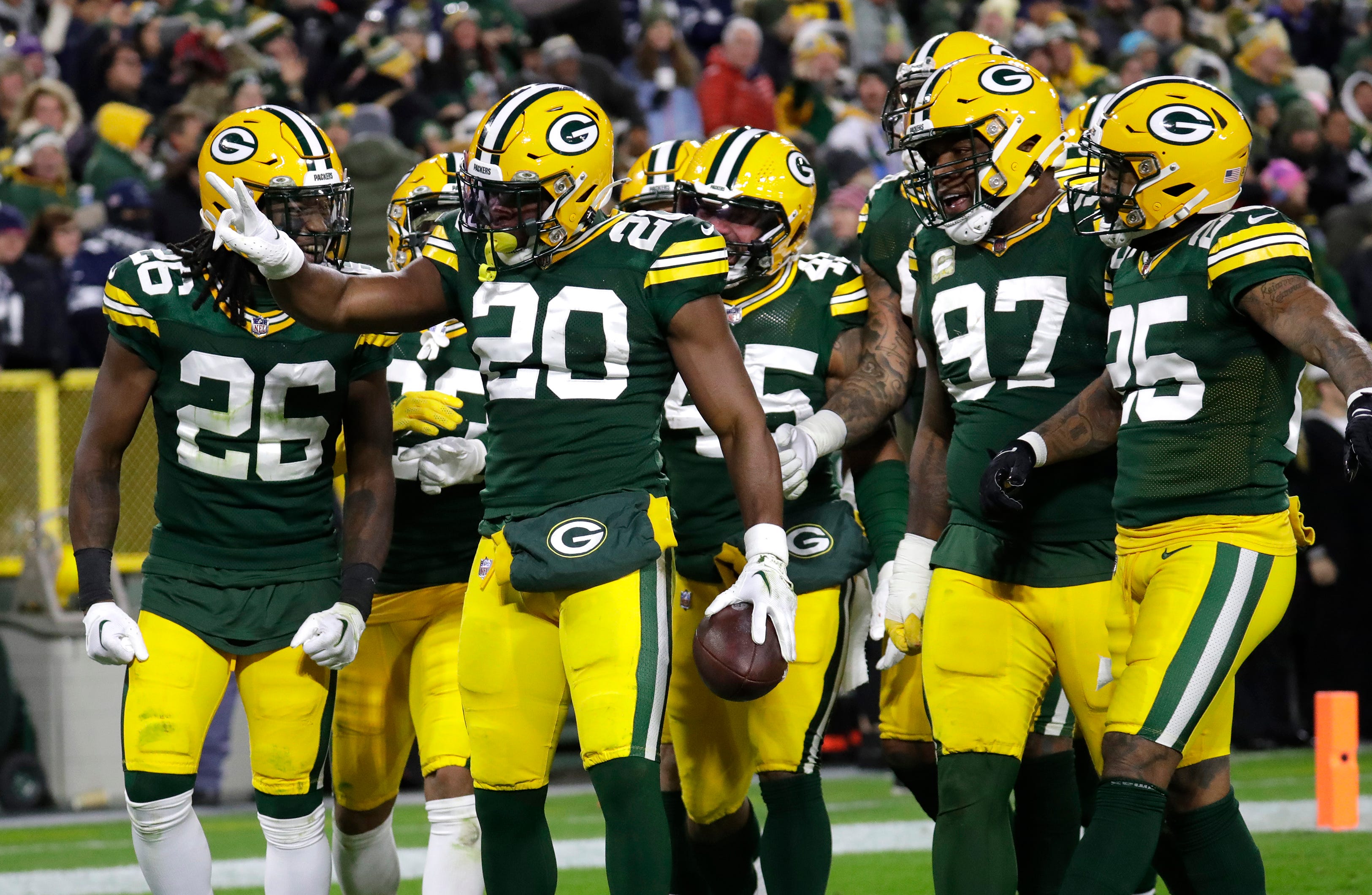 Green Bay Packers safety Rudy Ford (20) celebrates after getting his second interception against the Dallas Cowboys at Lambeau Field.
