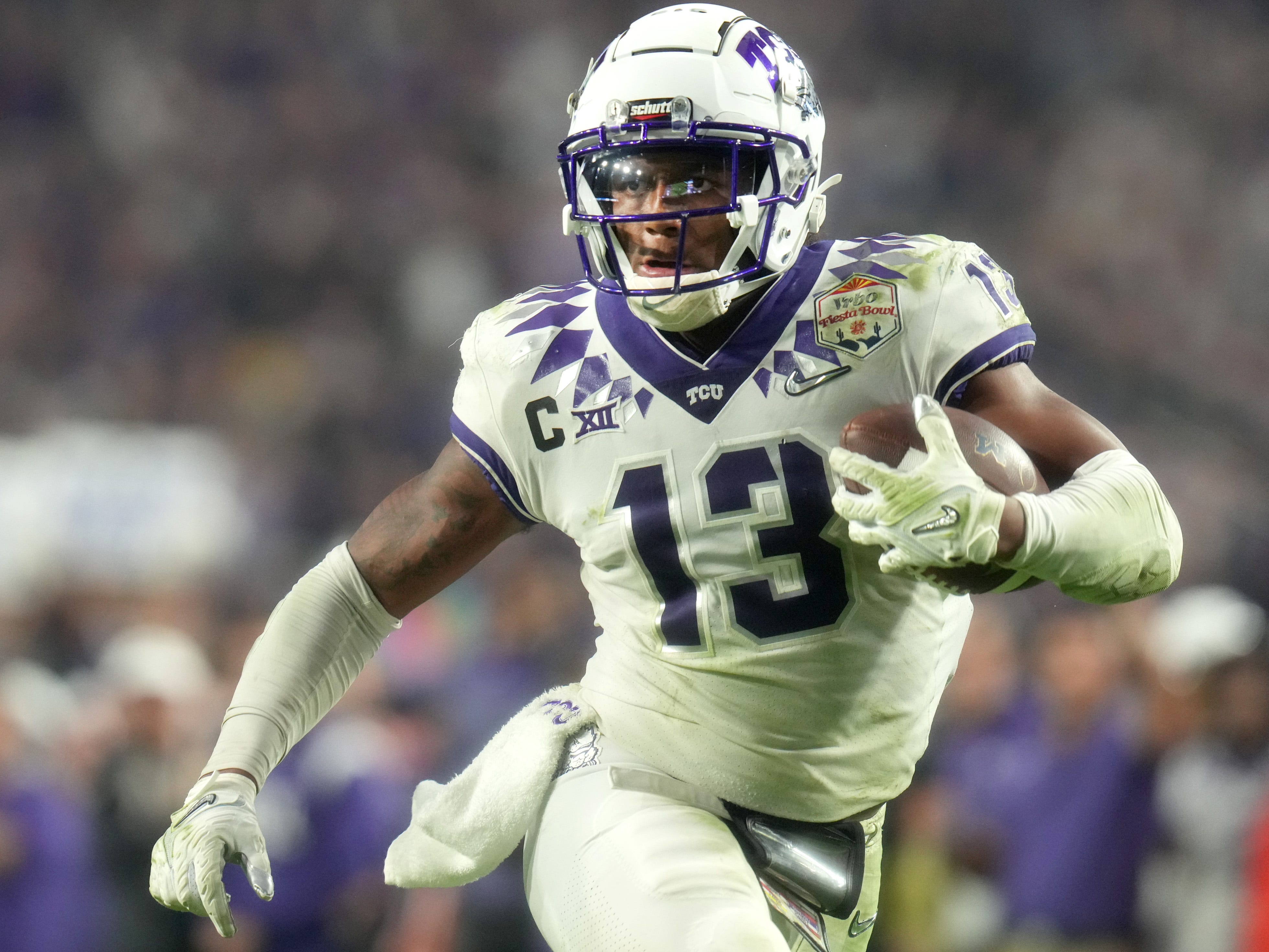 Dec 31, 2022; Glendale, Arizona, USA; TCU Horned Frogs linebacker Dee Winters (13) runs in an interception for a touchdown during their 51-45 win over the Michigan Wolverines in the Vrbo Fiesta Bowl at State Farm Stadium. Mandatory Credit: Joe Rondone-Arizona Republic Ncaa Fiesta Bowl Game