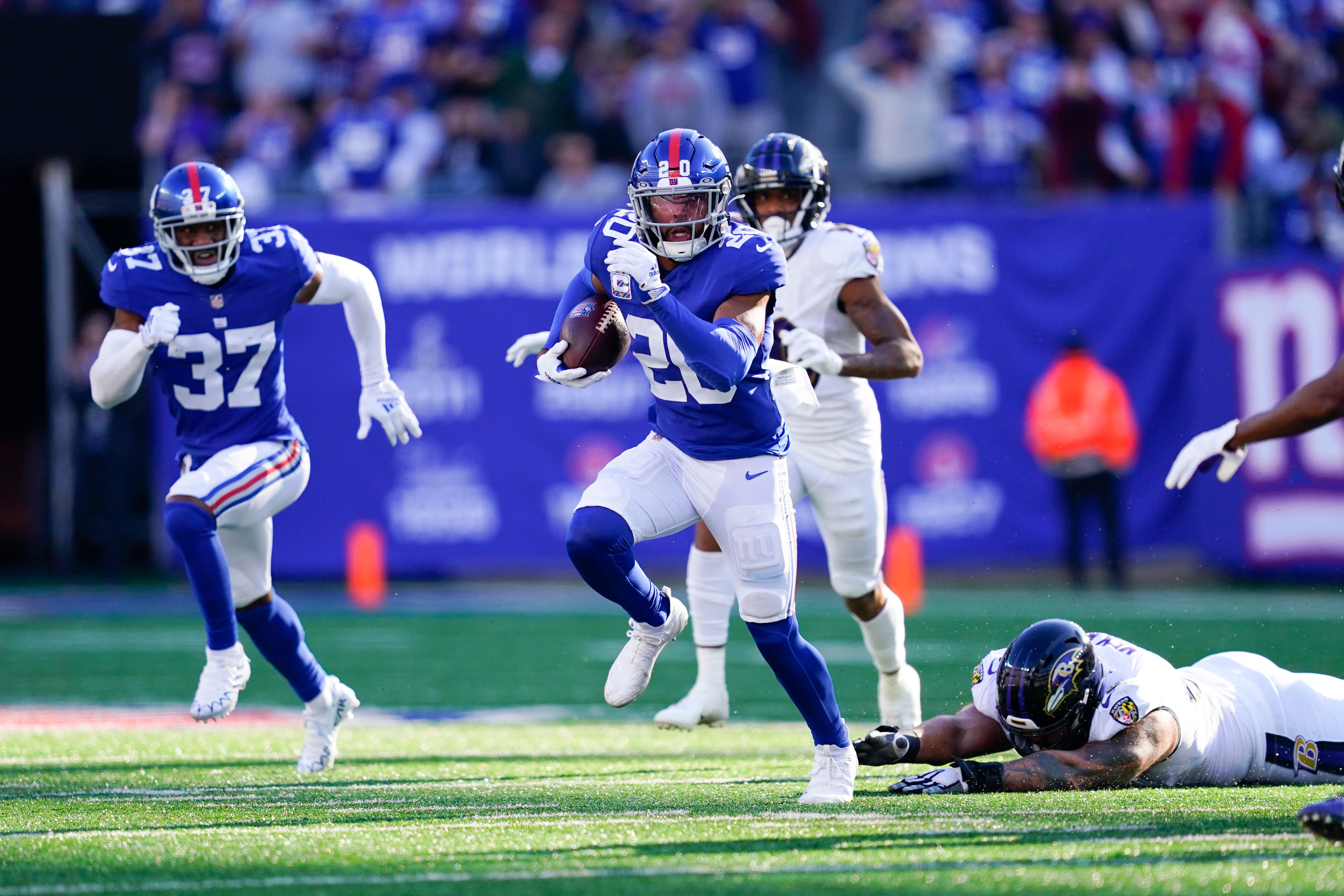 New York Giants S Julian Love returning a pick off of Baltimore Ravens Lamar Jackson
